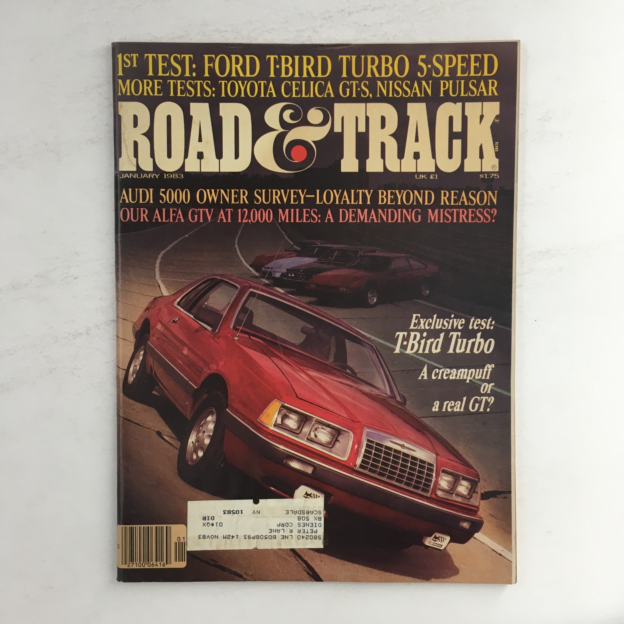 Road & Track Magazine January 1983 cover featuring Ford T-Bird Turbo, Audi 5000, and Alfa GTV with article highlights and vintage automotive design.