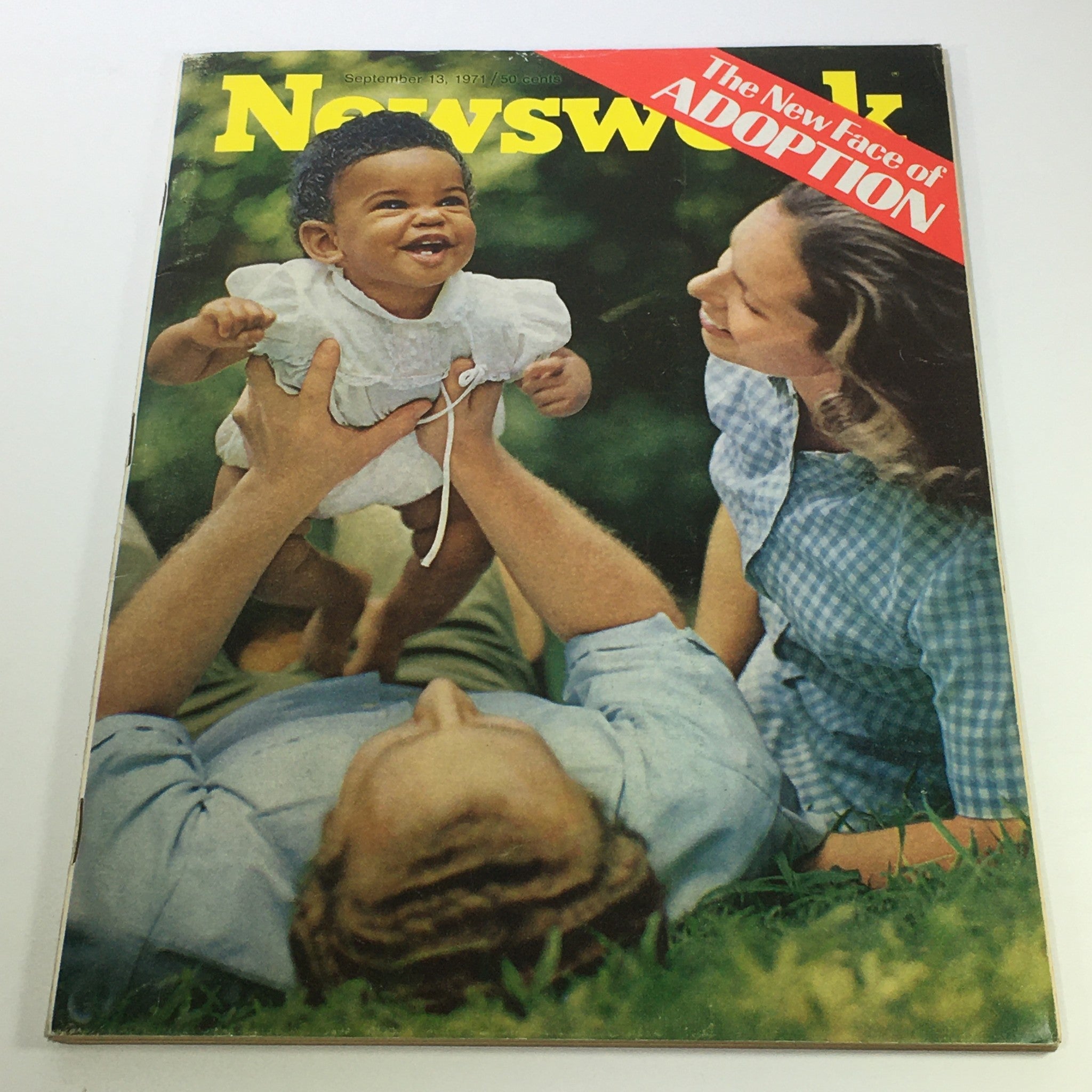 Cover of VTG Newsweek Magazine from September 13, 1971, featuring a joyful baby being held by an adult, representing the theme 'The New Face of Adoption'.