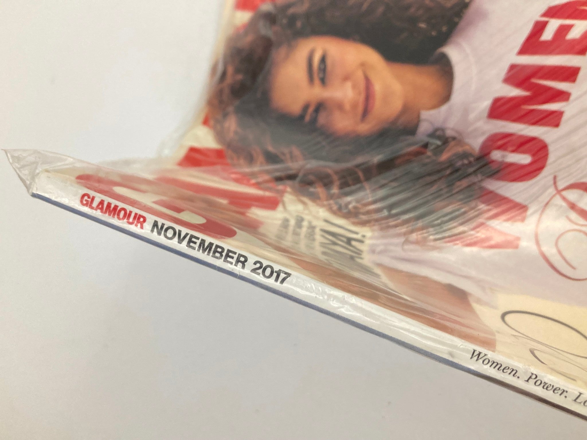 Close-up view of Glamour Magazine November 2017, highlighting the title and sealed packaging, ideal for vintage magazine enthusiasts.