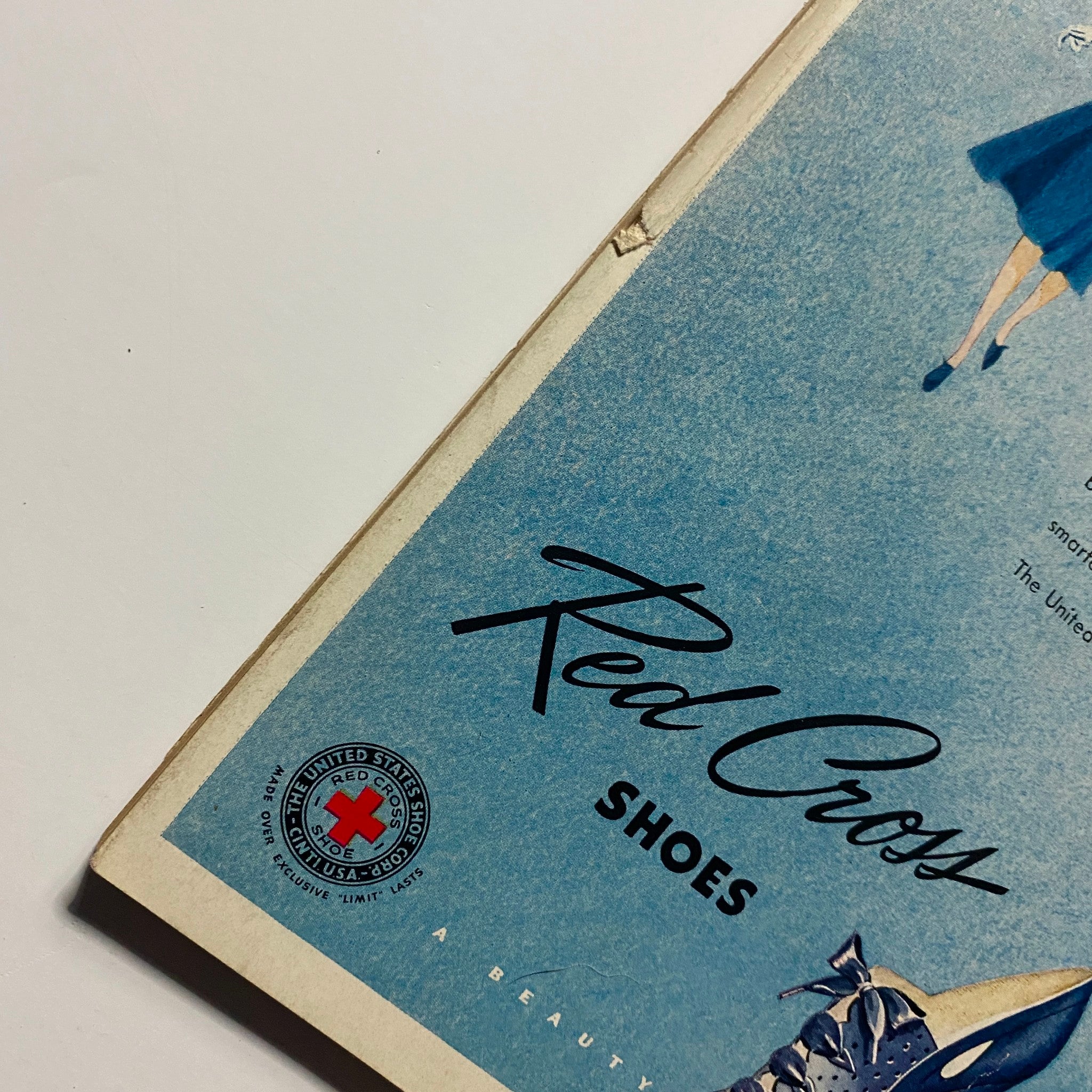 Close-up of the Red Cross Shoes advertisement in GLAMOUR OF HOLLYWOOD Magazine April 1939, featuring a stylish design and branding elements.