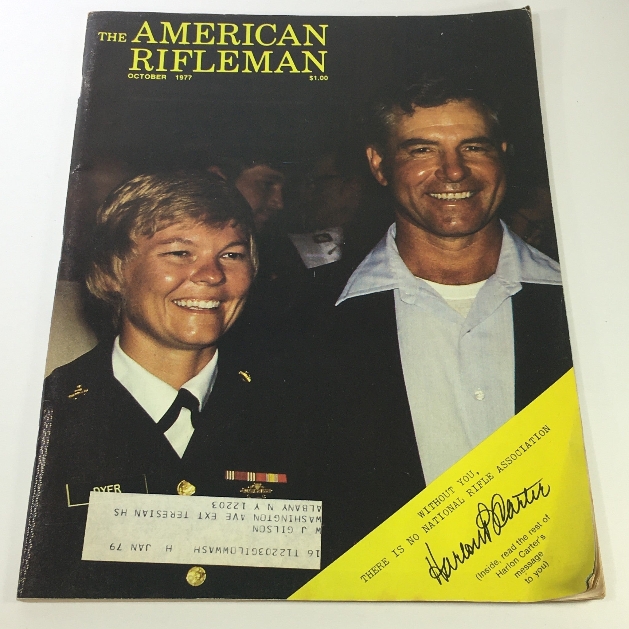 Cover of VTG The American Rifleman Magazine October 1977 featuring Harlon Carter's Message, showing two individuals, one in military uniform with medals and the other in a suit, both smiling.