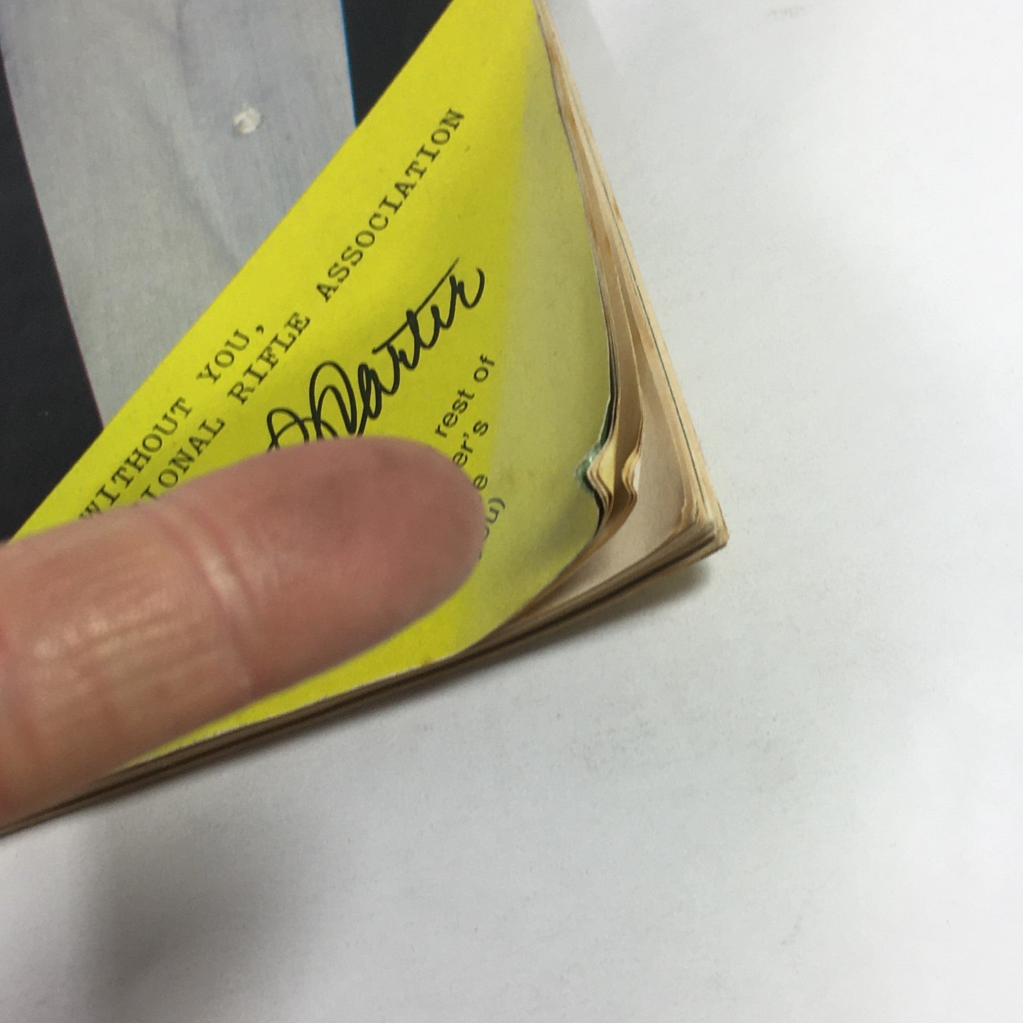 Detail of the VTG The American Rifleman Magazine October 1977, highlighting wear on the binding and edges, with Harlon Carter's signature visible.