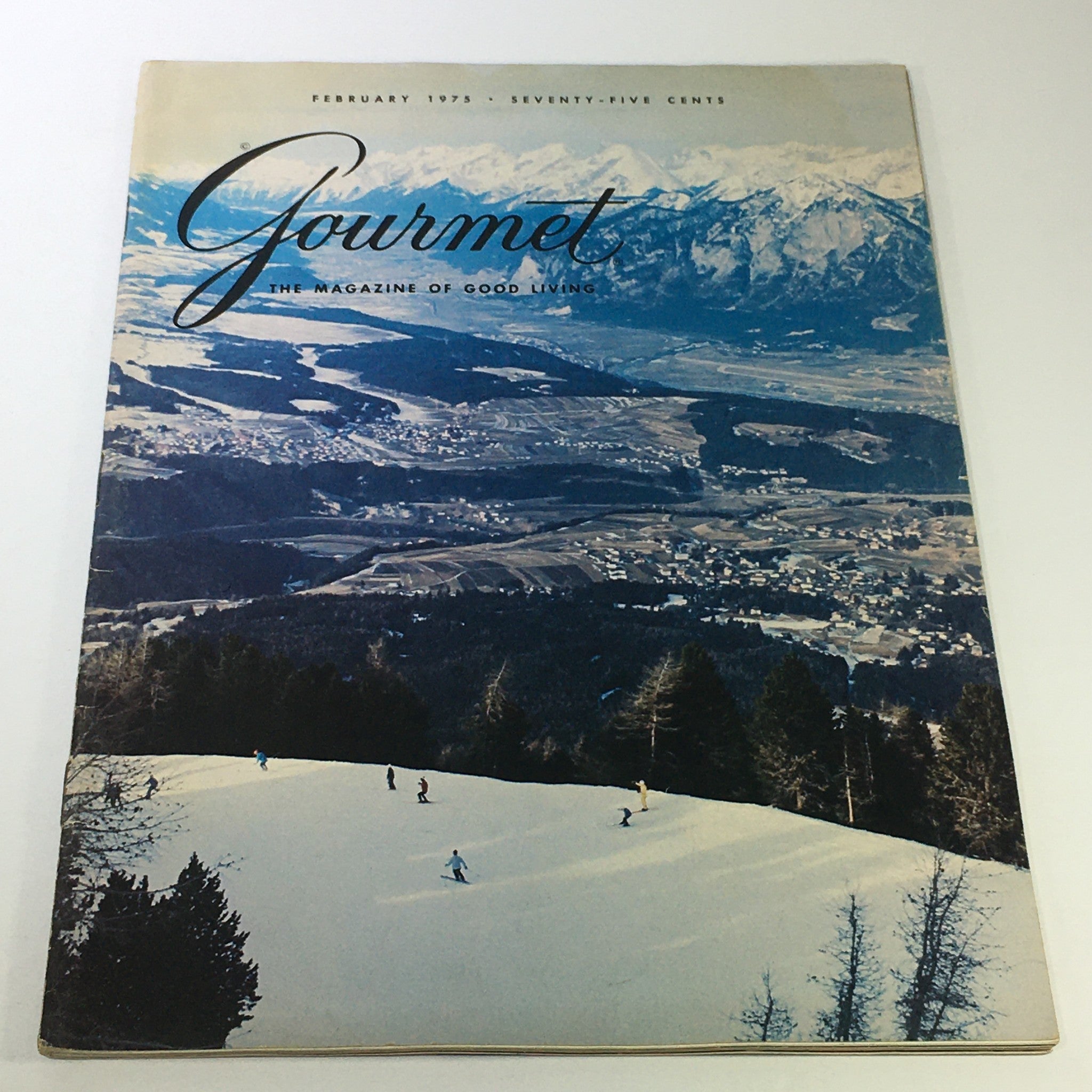 VTG Gourmet The Magazine of Good Living February 1975 cover featuring a picturesque snow-covered landscape and skiing scene, capturing the essence of gourmet living in the 1970s.