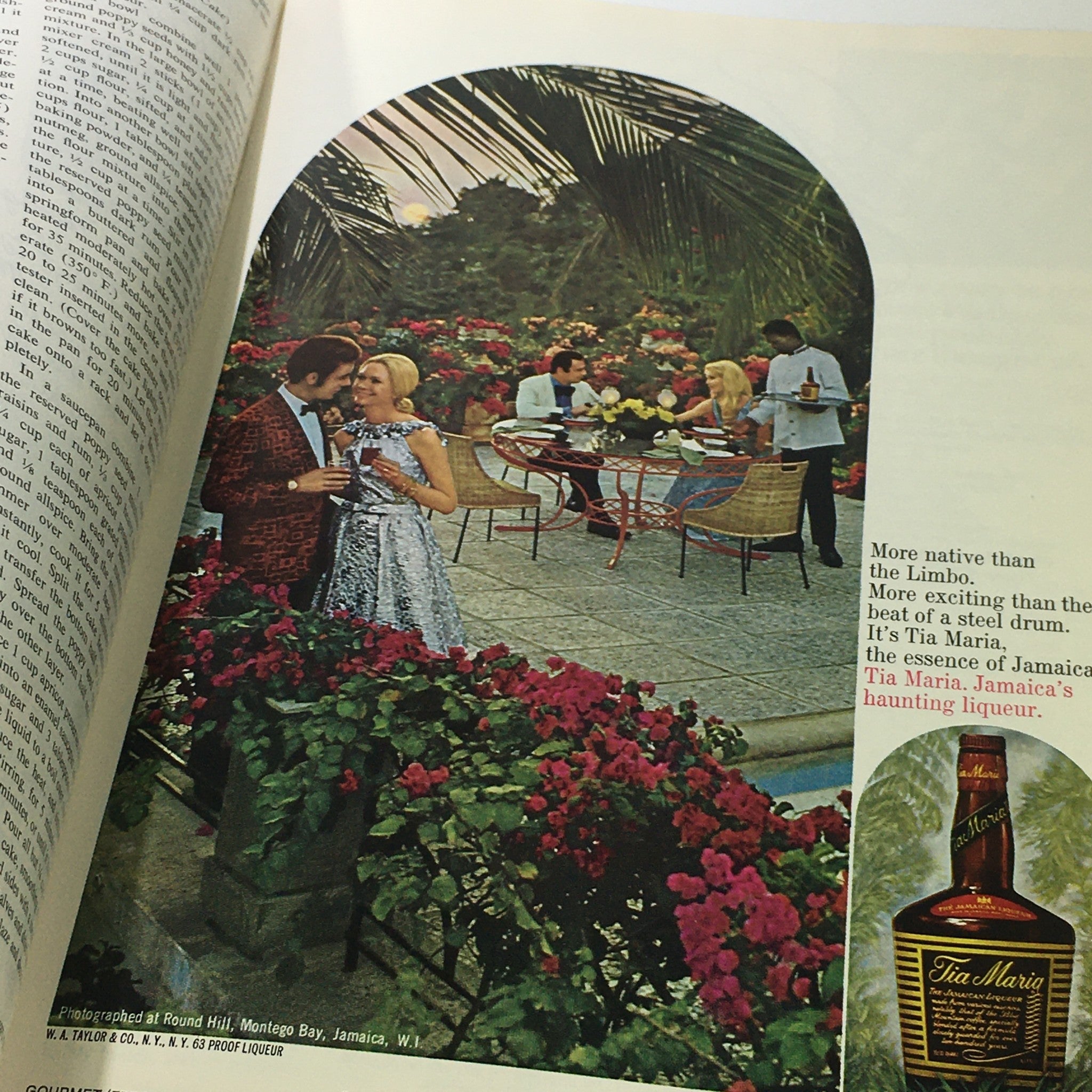 Image from VTG Gourmet The Magazine of Good Living February 1975 featuring a glamorous outdoor dining scene with a couple enjoying drinks surrounded by colorful flowers. The image captures the essence of 1970s gourmet living.