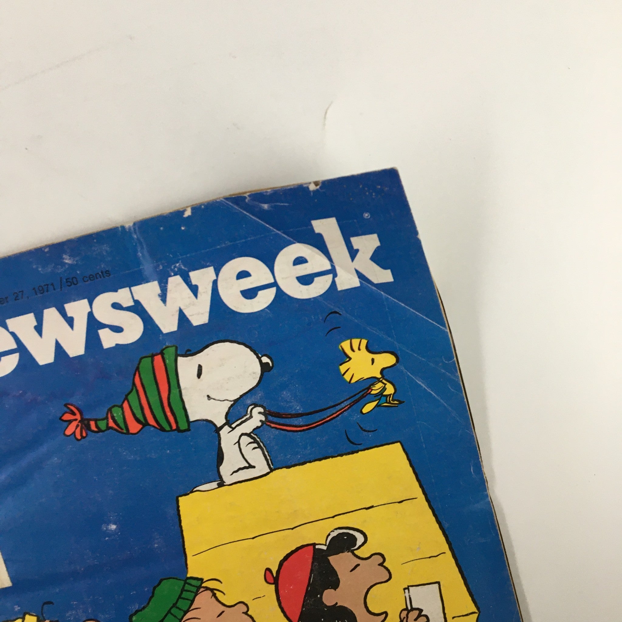 Close-up view of the vintage Newsweek magazine cover from December 27, 1971 featuring Snoopy and Woodstock celebrating Christmas.