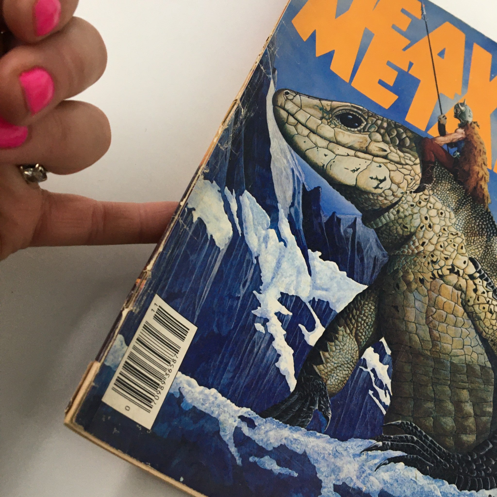 Angle view of the front cover of the VTG Heavy Metal Magazine November 1977 Vol I #8 The Feet Upon Stomach, highlighting the vibrant colors and prominent title.