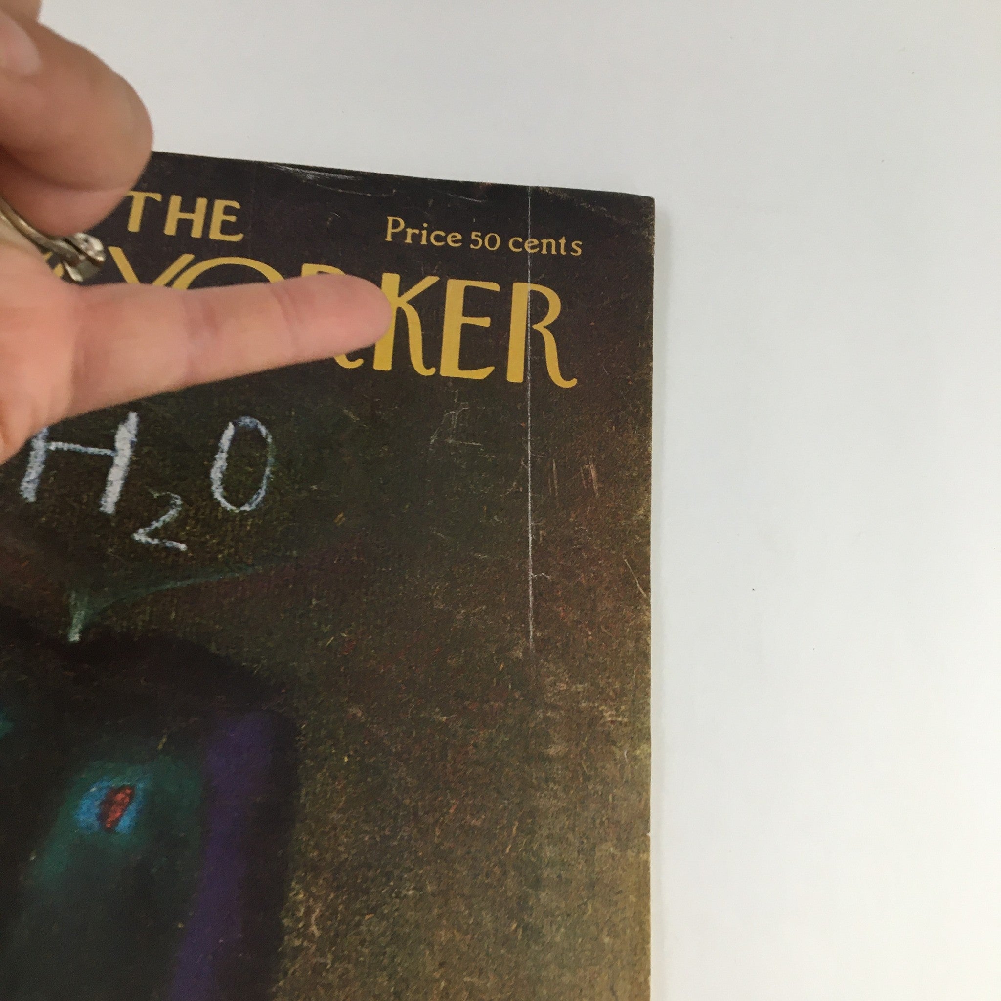 Close-up view of The New Yorker Magazine August 26, 1974 cover highlighting the title and price of 50 cents, with a finger pointing at the text for emphasis.