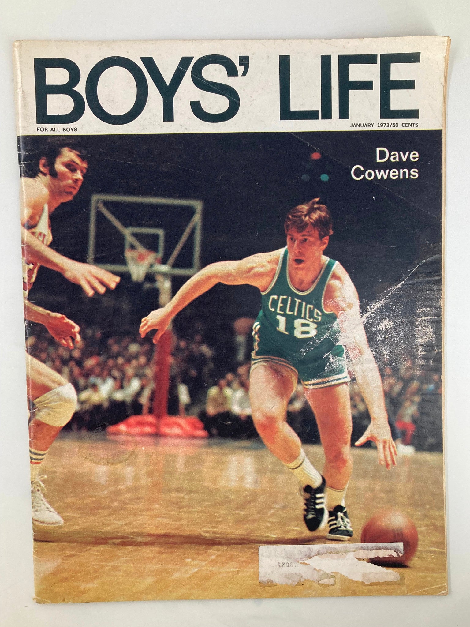 Cover of VTG Boys' Life Magazine from January 1973 featuring Dave Cowens in action during a basketball game, showcasing the theme of teamwork.