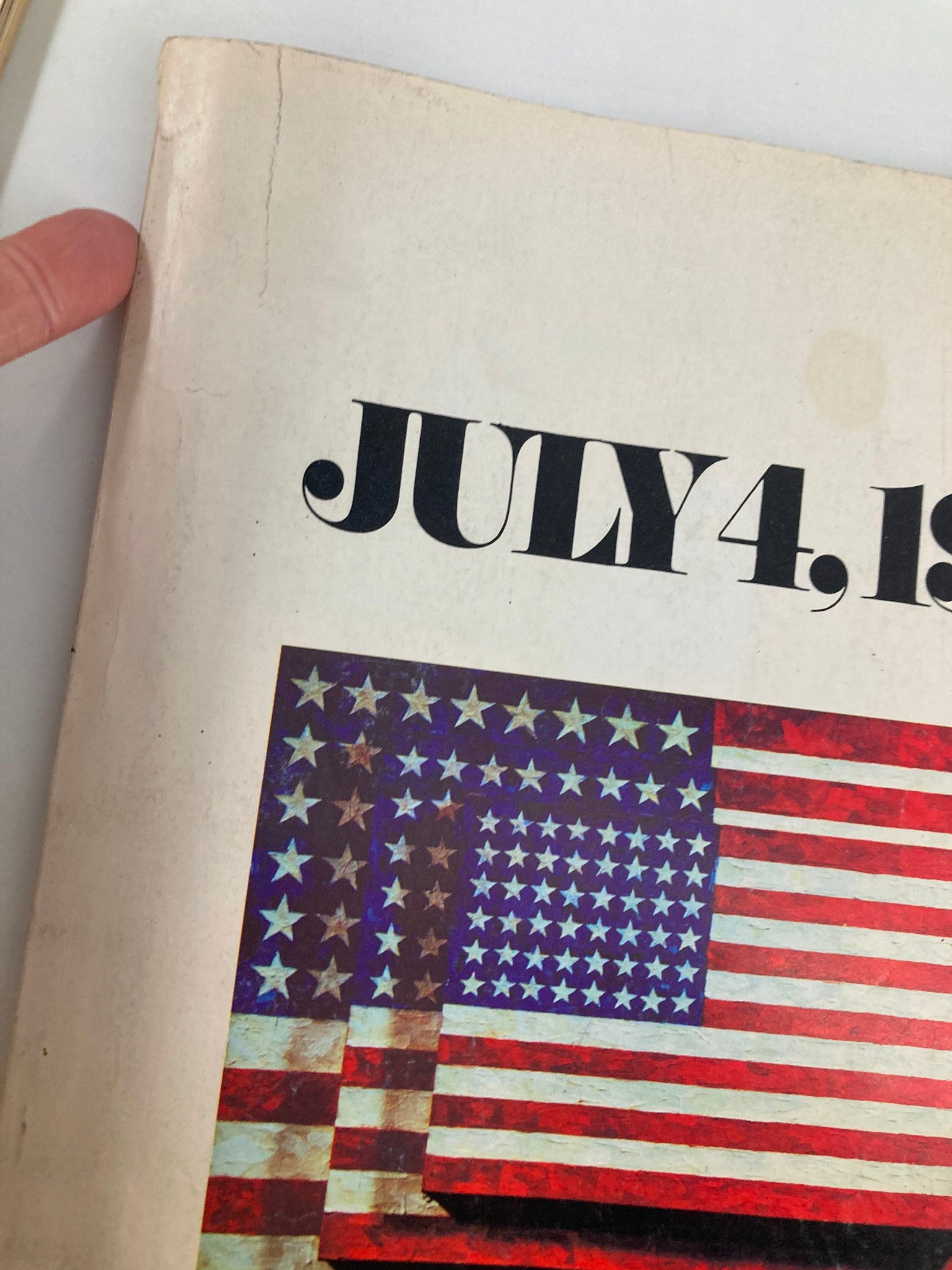 Close-up view of the spine and cover of the Vintage The Washington Post Magazine July 4 1976, showing some wear with a visible crack and faded colors.