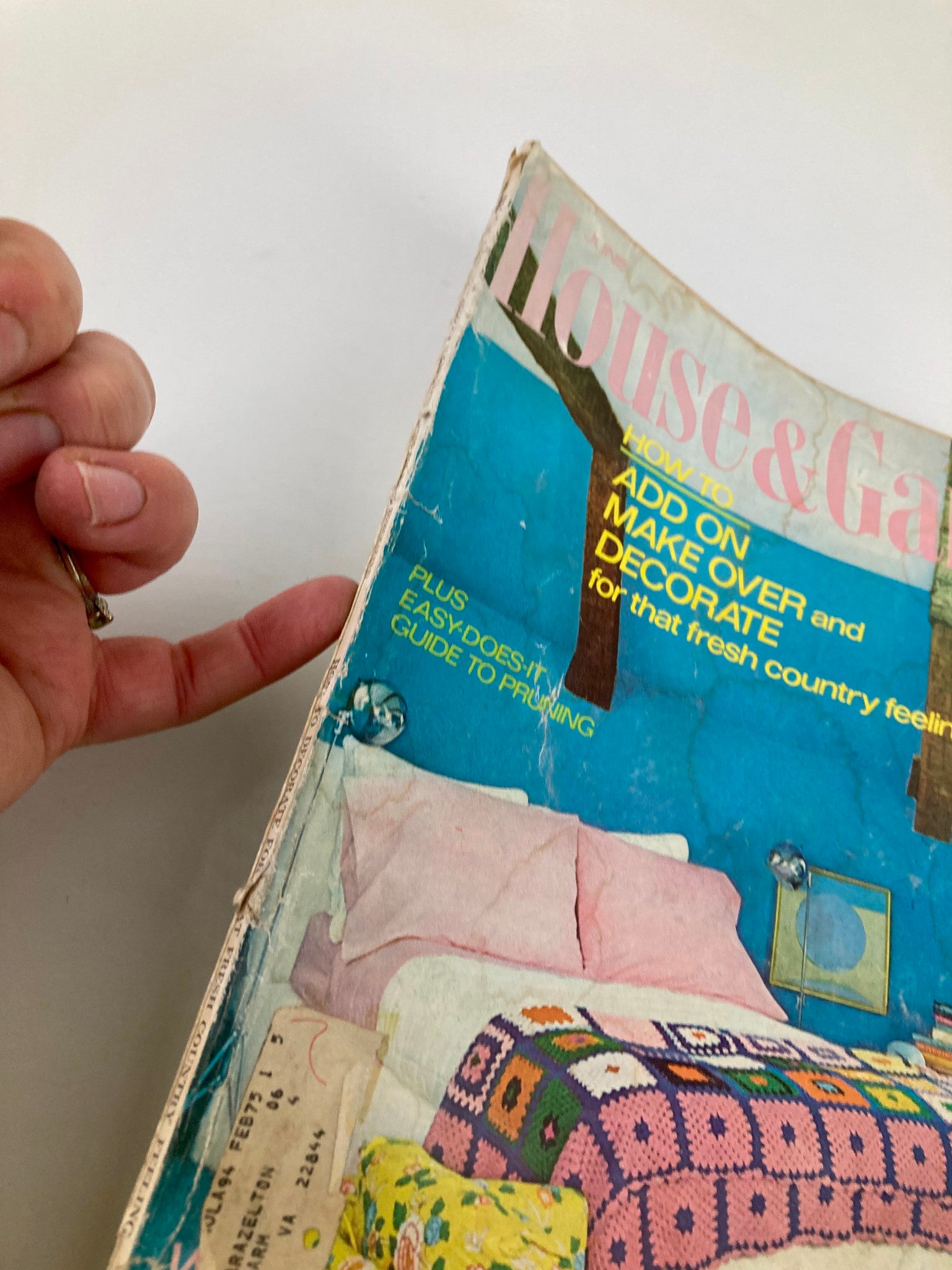 Side view of the VTG Better Homes & Gardens Magazine June 1974 cover, displaying the title 'Easy-Does-It Guide to Pruning' and a person's hand pointing at the magazine.