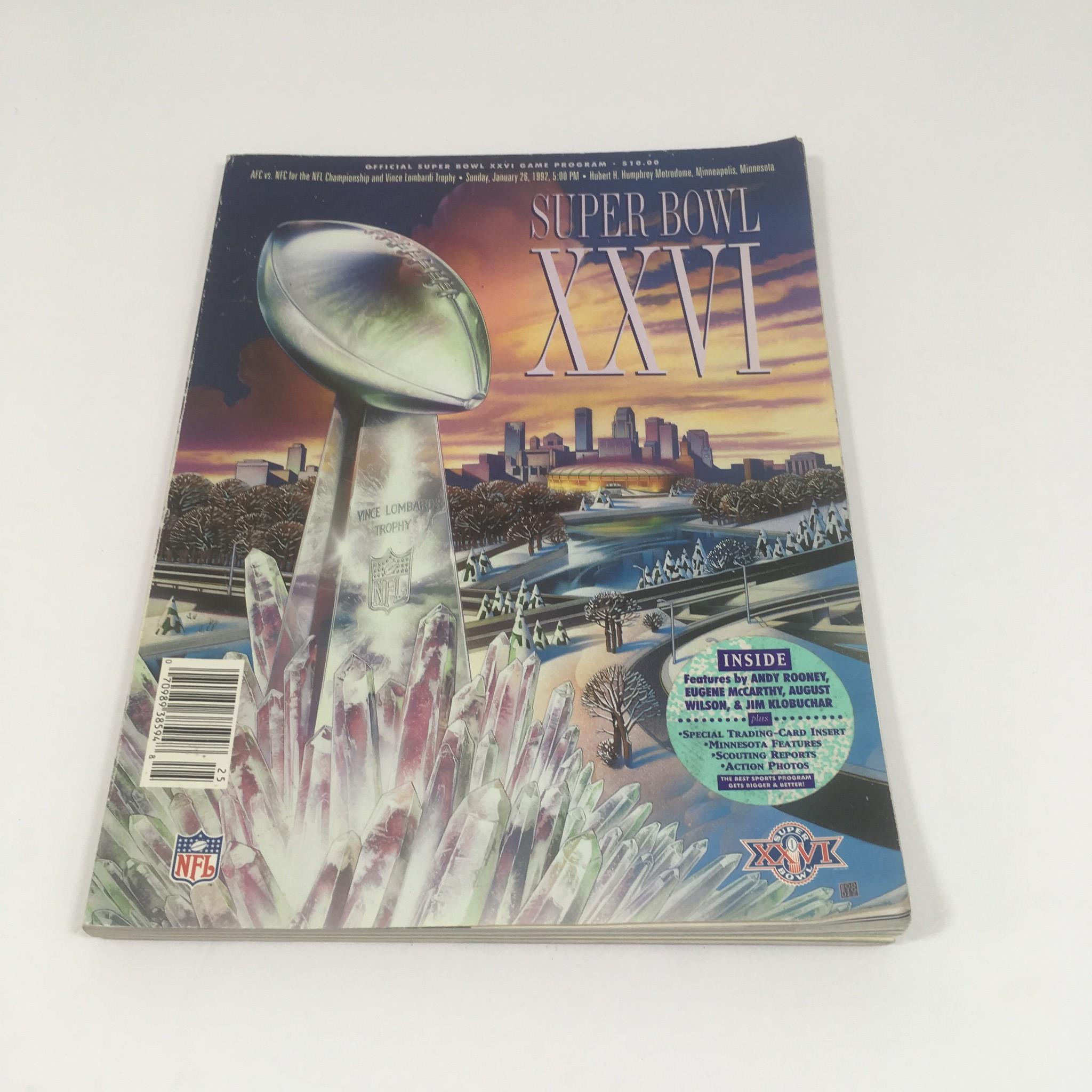 Super Bowl XXVI Game Program January 26, 1992 displaying the iconic Vince Lombardi Trophy alongside vibrant illustrations of the Minneapolis skyline and event features.