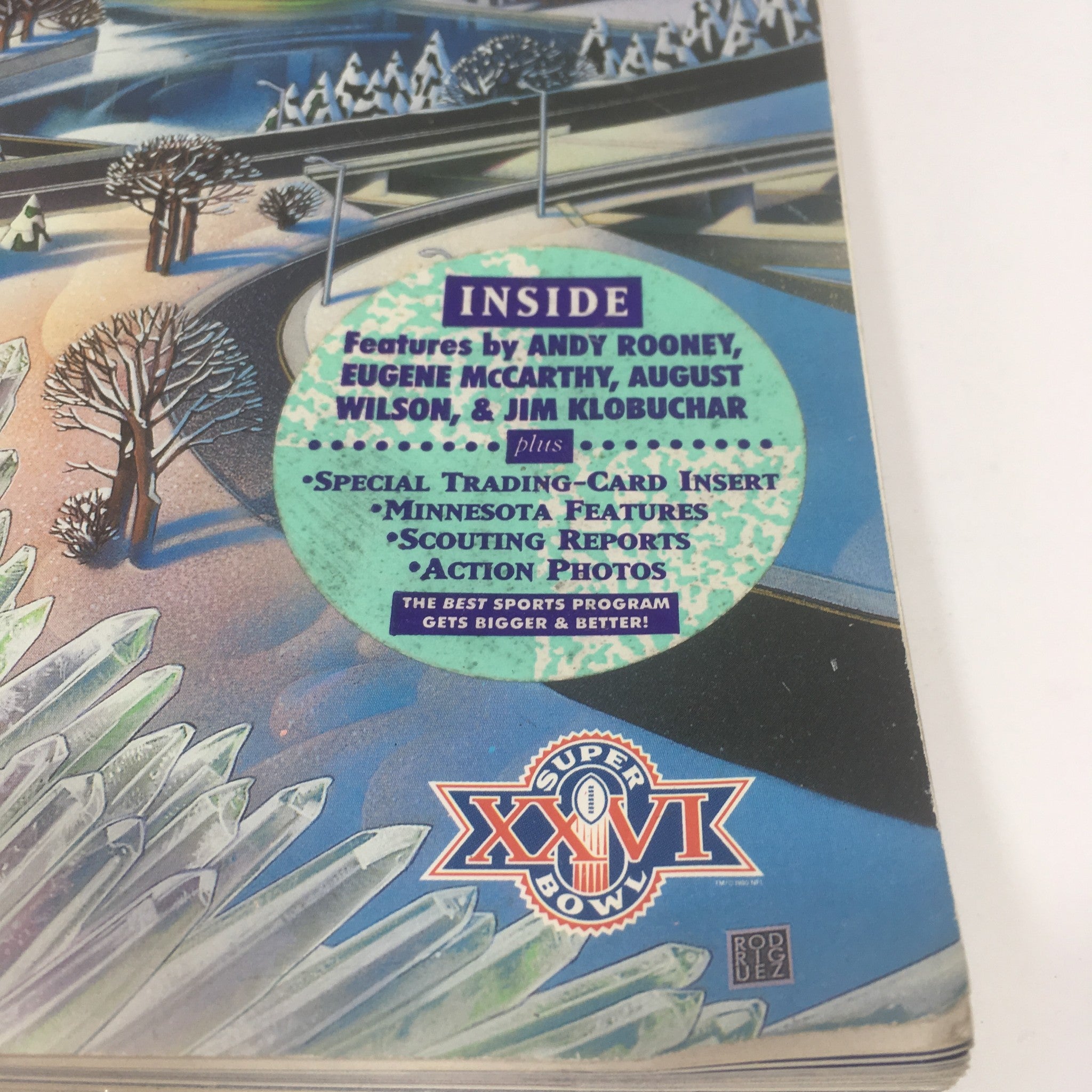 Inside cover of the Super Bowl XXVI Game Program from January 26, 1992, featuring highlights such as contributions from Andy Rooney, Eugene McCarthy, August Wilson, and Jim Klobuchar, alongside special inserts and action photos.