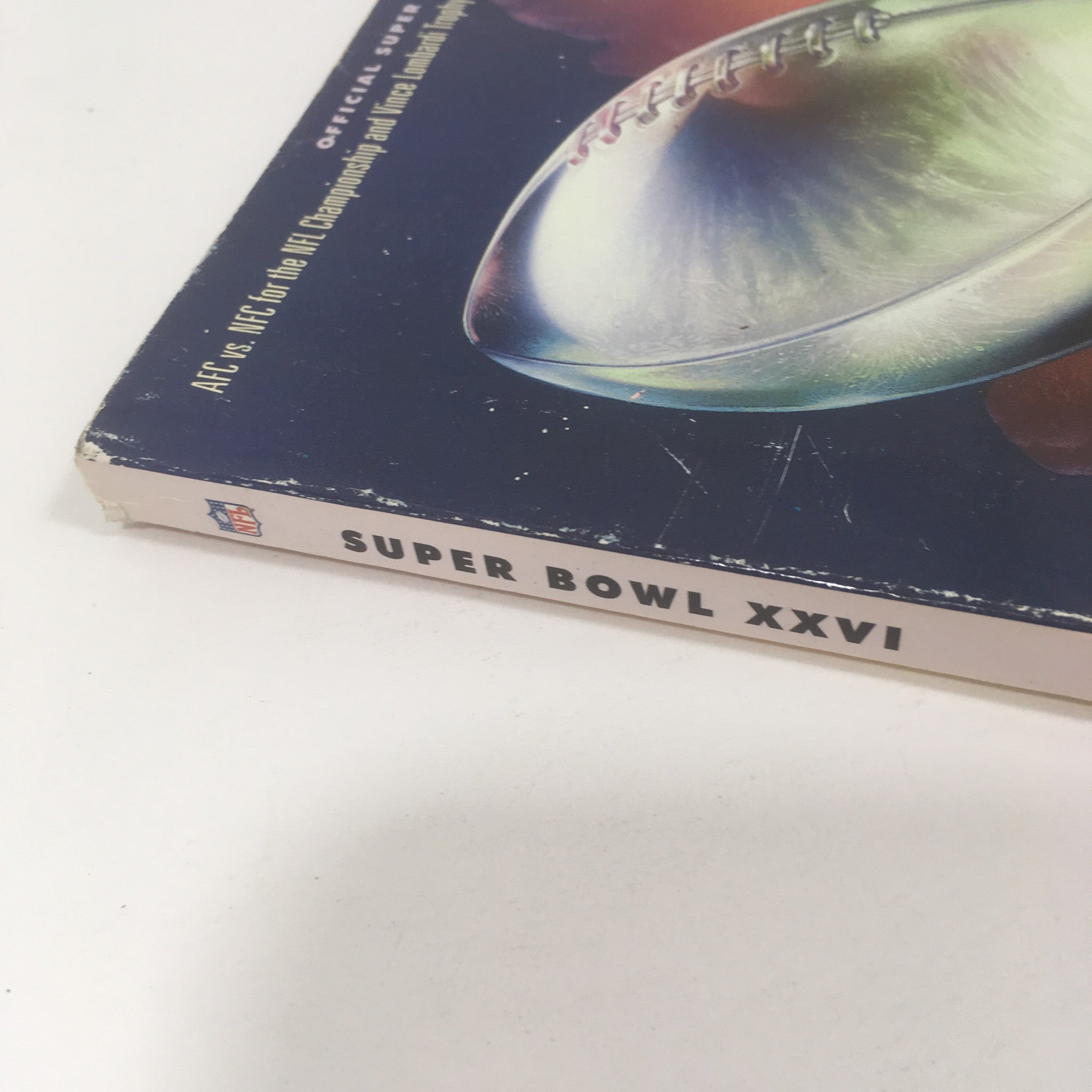 Side view of the Super Bowl XXVI Game Program from January 26, 1992, showcasing the title and NFL logo.