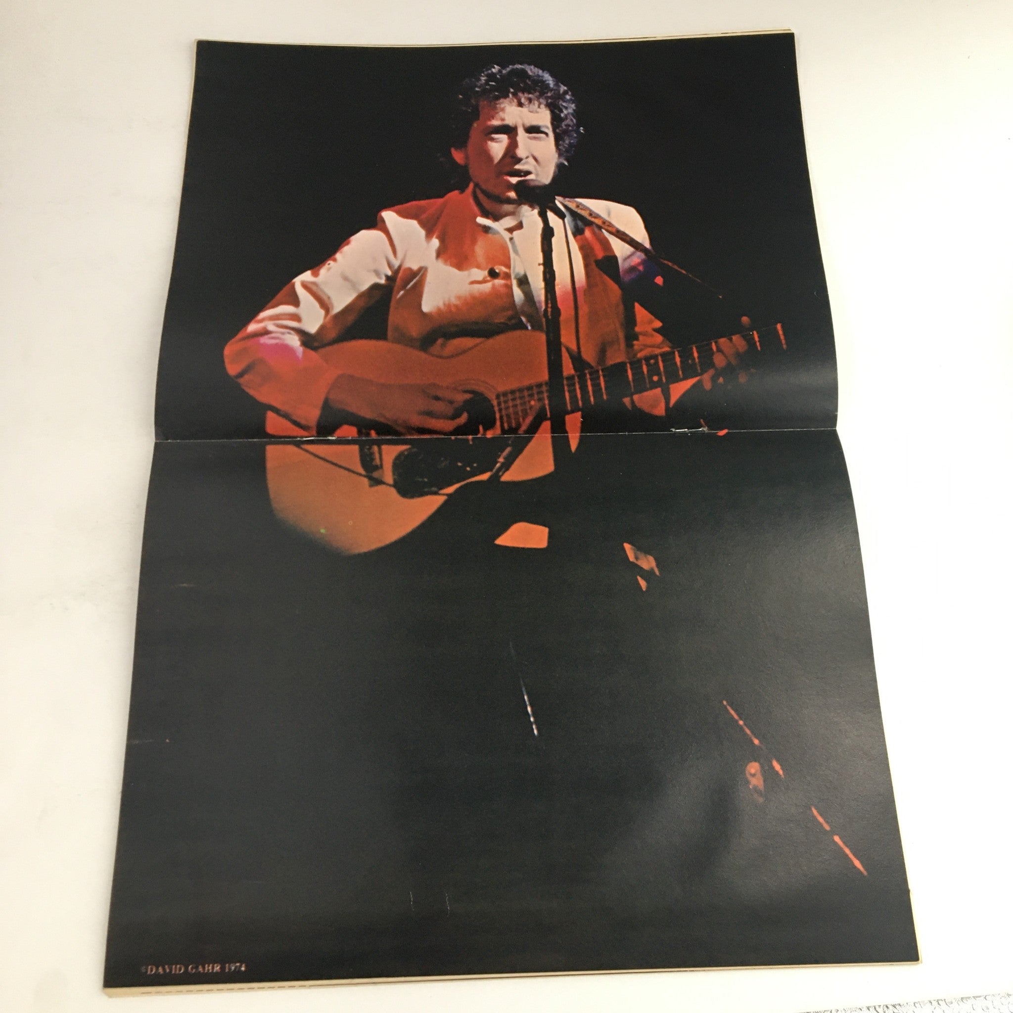 Image from Hit Parader Magazine June 1974 featuring a musician on stage holding a guitar, showcasing the era's vibrant rock scene. This collectible magazine includes iconic acts like ELP, The Allman Brothers, Led Zeppelin, and Peter Wolf.