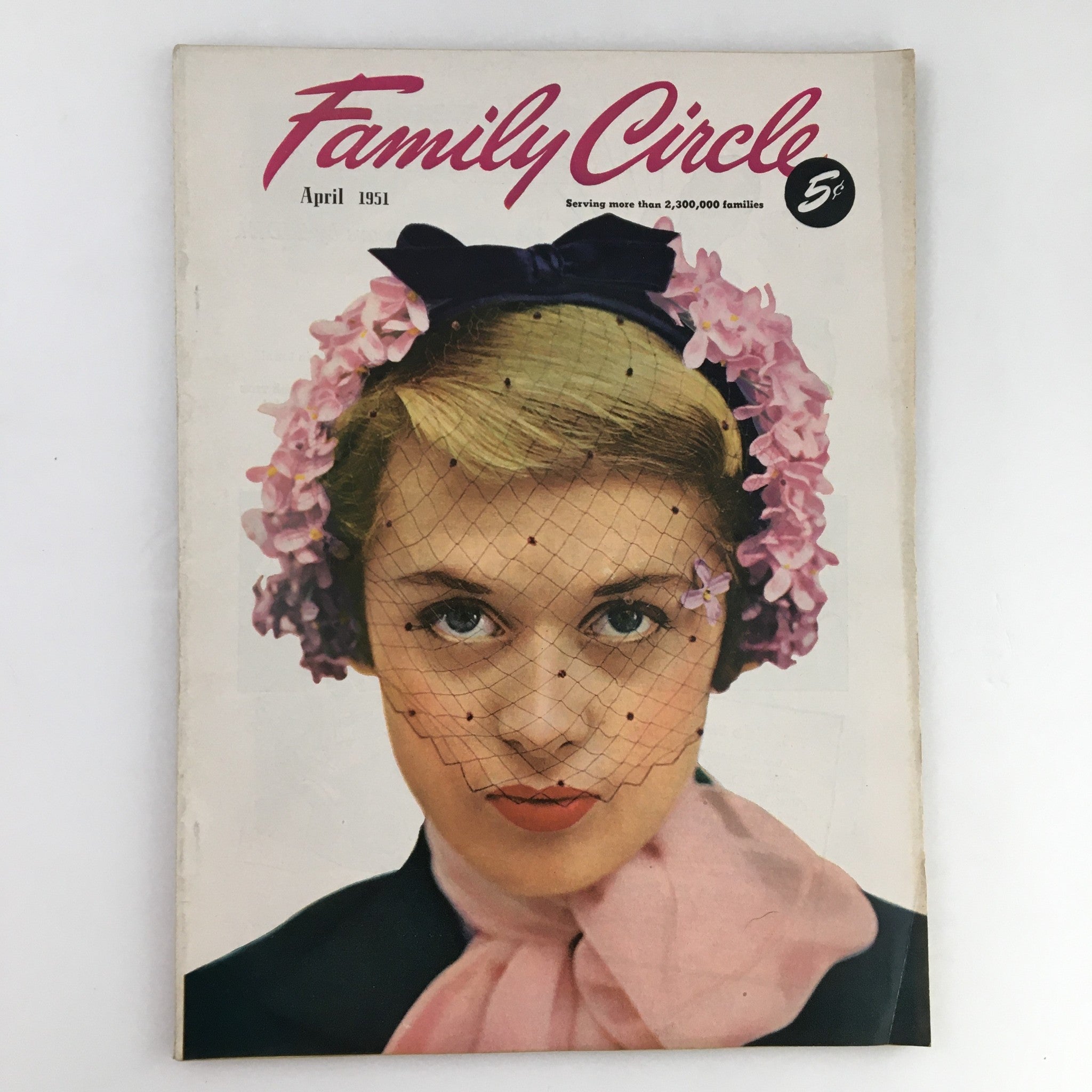 The Family Circle Magazine April 1951 cover featuring a woman with a floral headpiece and veil, showcasing vintage fashion and style.