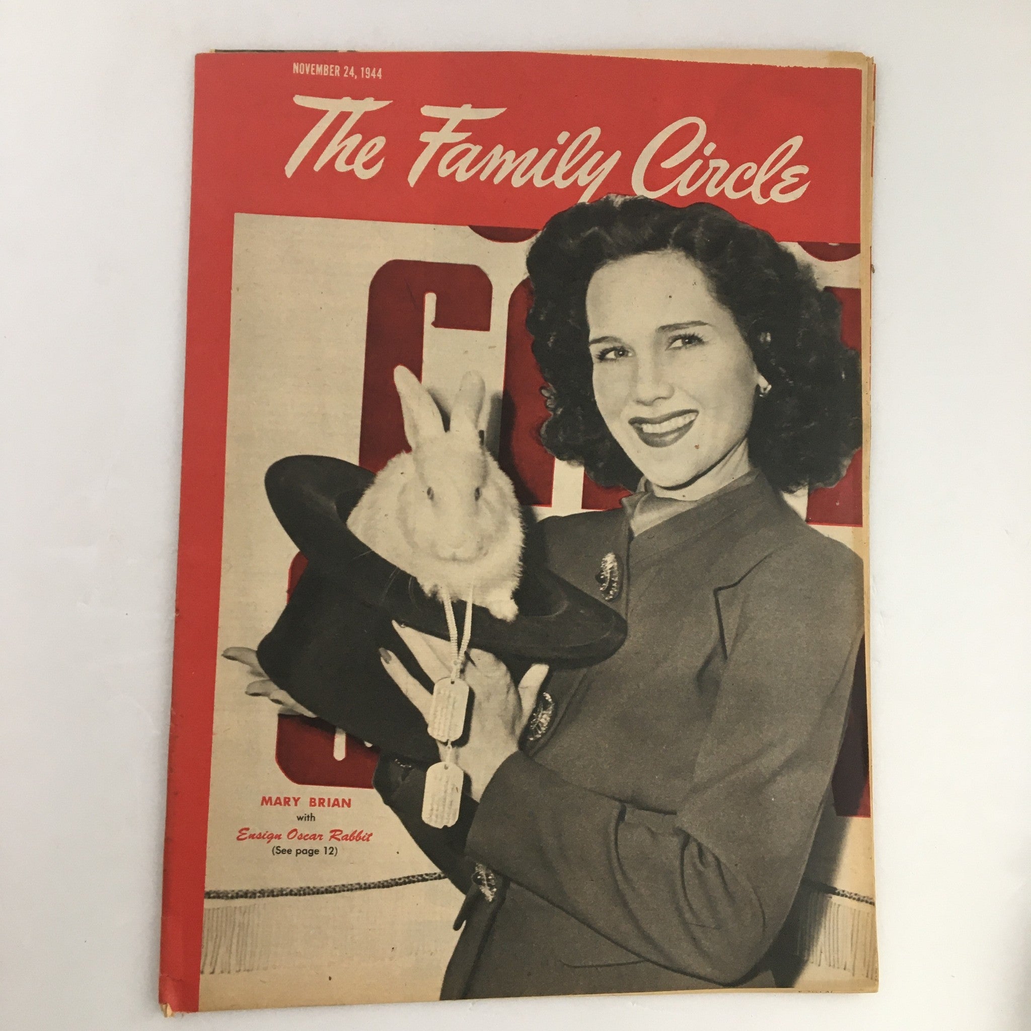 The Family Circle Magazine cover from November 24, 1944, featuring actress Mary Brian holding a bunny, Ensign Rabbit, showcasing vintage 1940s style.