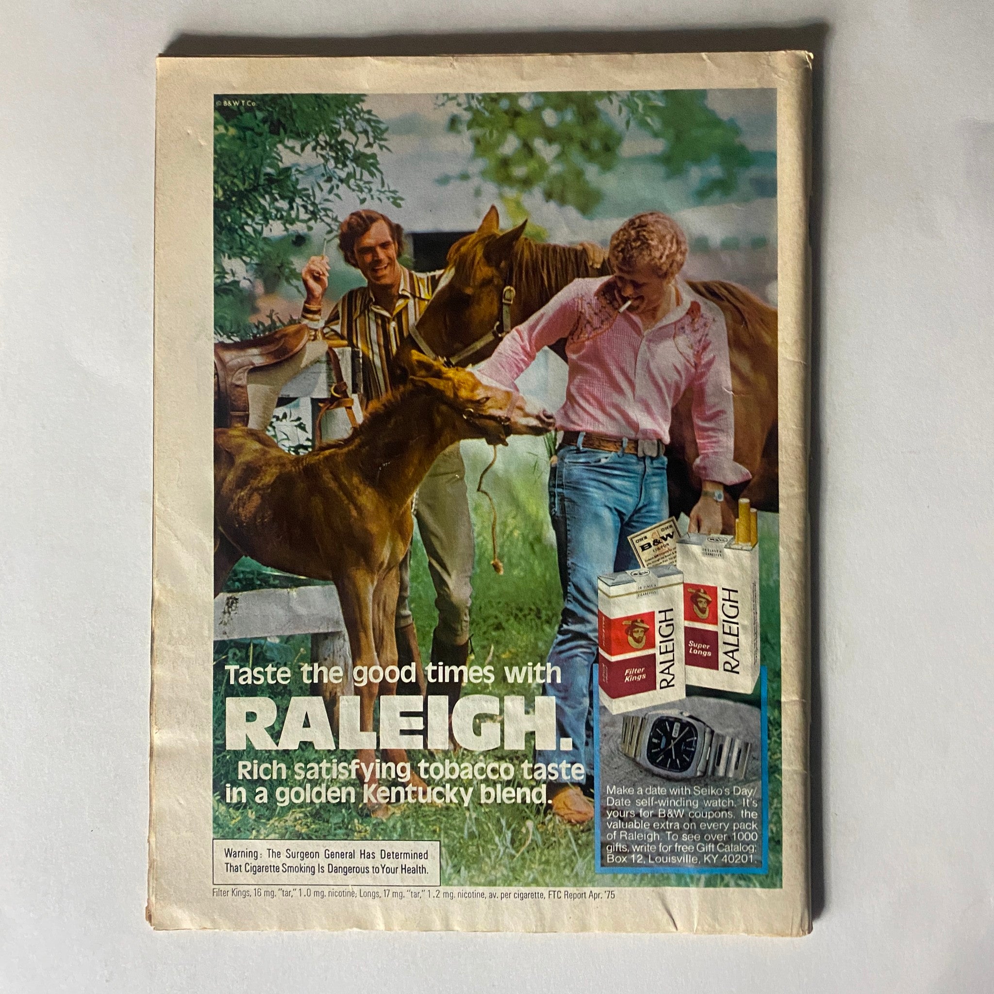 Vintage advertisement from the VTG People Weekly Magazine November 10 1975 featuring Raleigh cigarettes. Illustrates marketing trends and lifestyle imagery of the era.