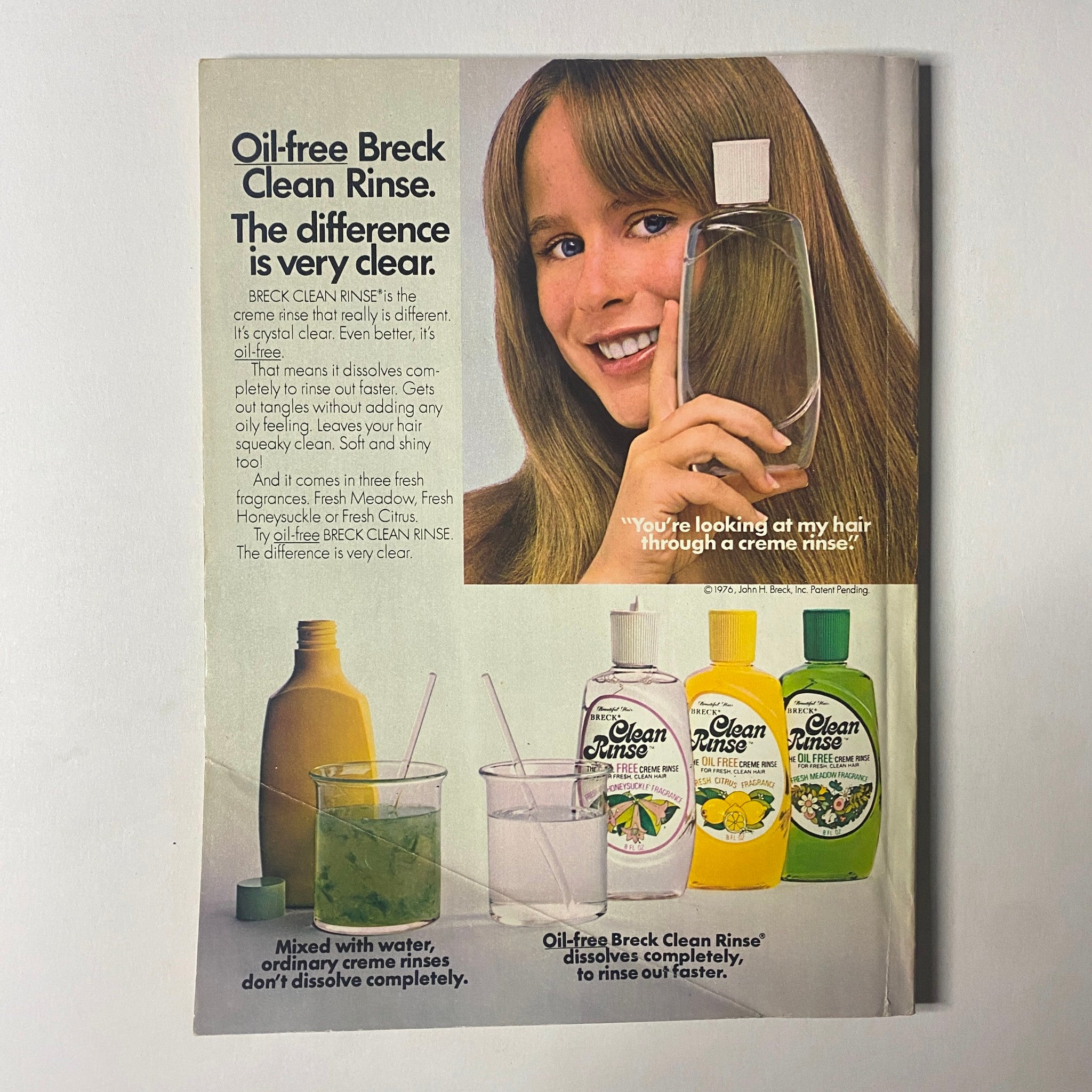 Advertisement for Oil-free Breck Clean Rinse featured in Seventeen Magazine March 1977, showcasing a smiling young woman holding a bottle and highlighting hair care benefits with a clear visual of various rinses.