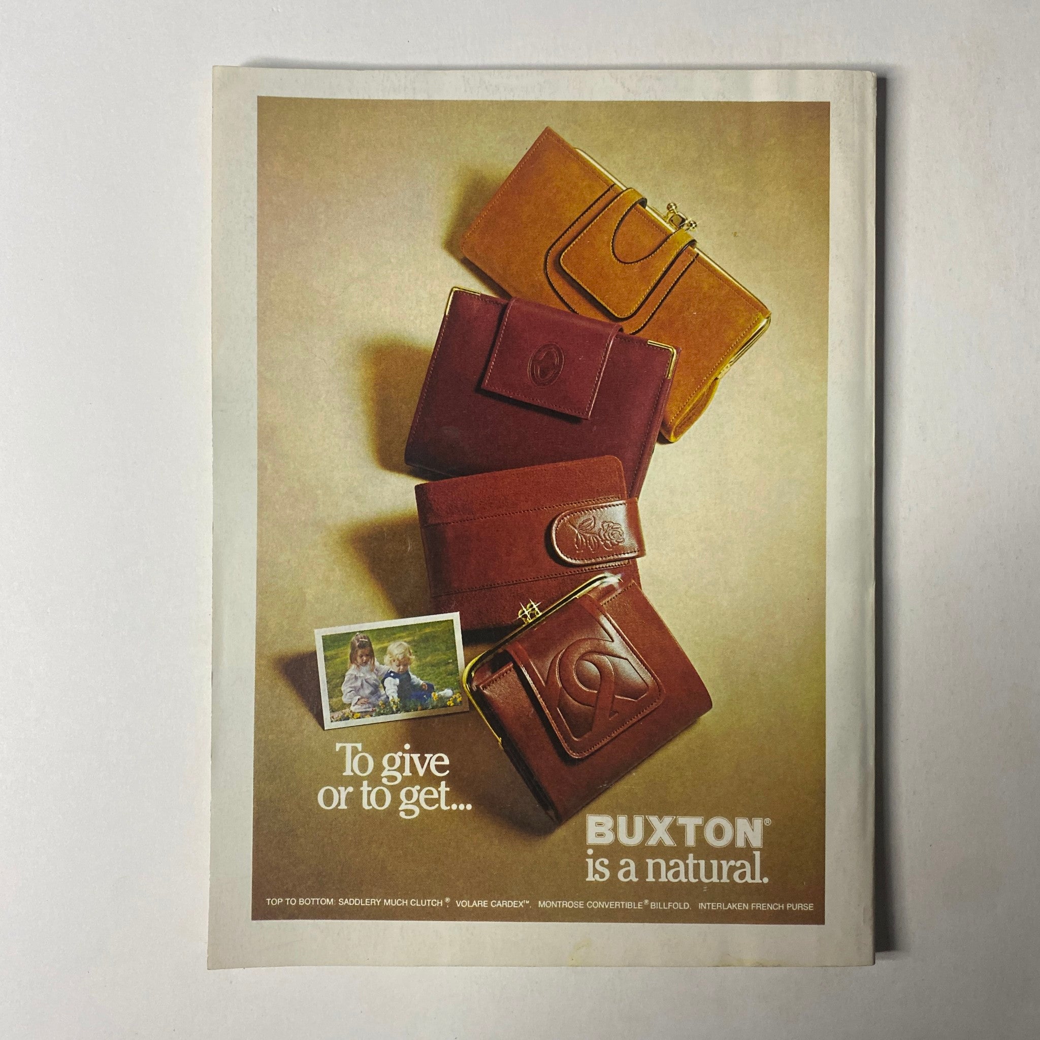Vintage advertisement for Buxton featuring leather wallets and bags with the tagline 'To give or to get...' from Seventeen Magazine December 1978 with Bill Cosby and Erika Cosby on the cover.