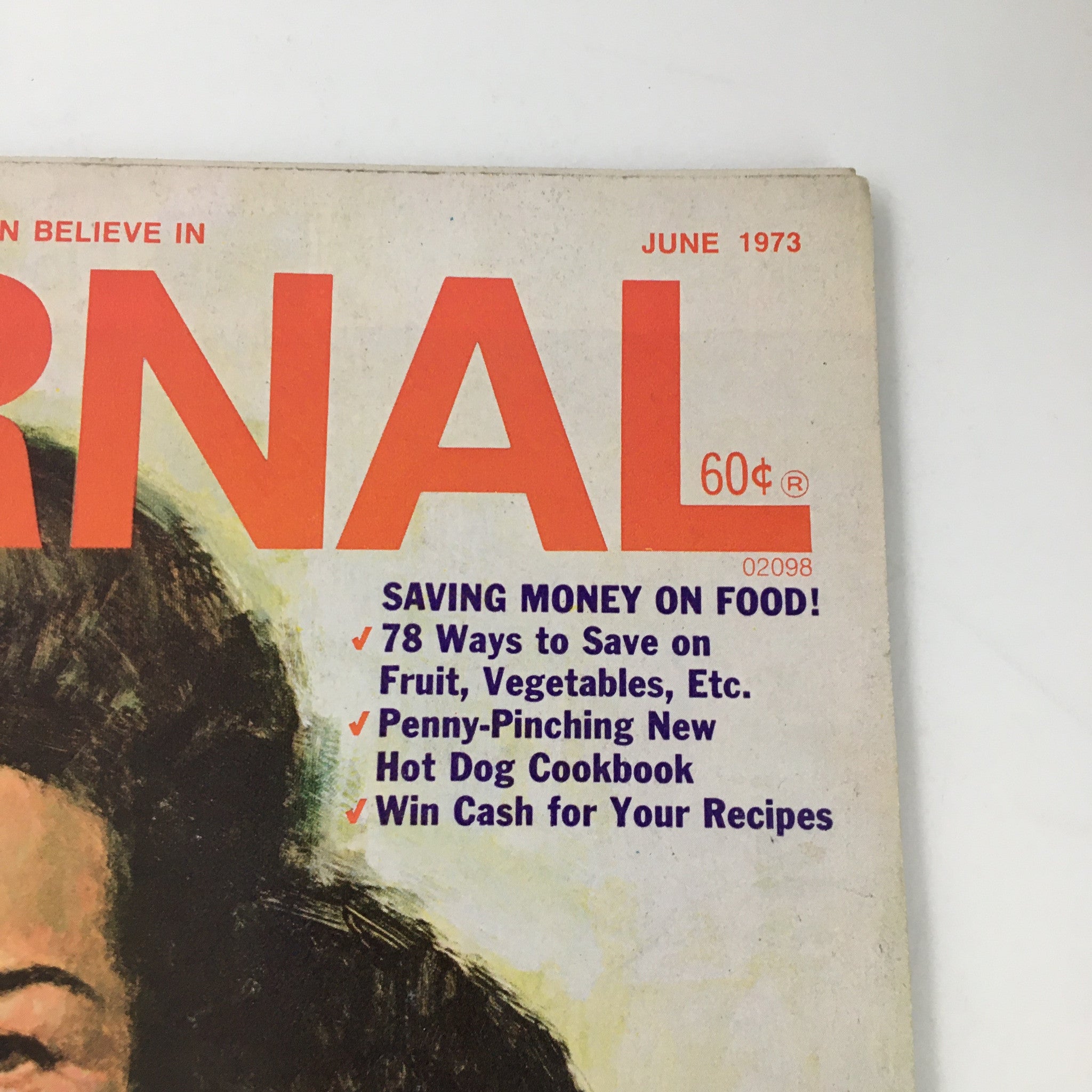 Close-up of the cover of Ladies' Home Journal Magazine June 1973, highlighting articles about saving money on food, featuring vibrant graphics and significant content focusing on women's roles.