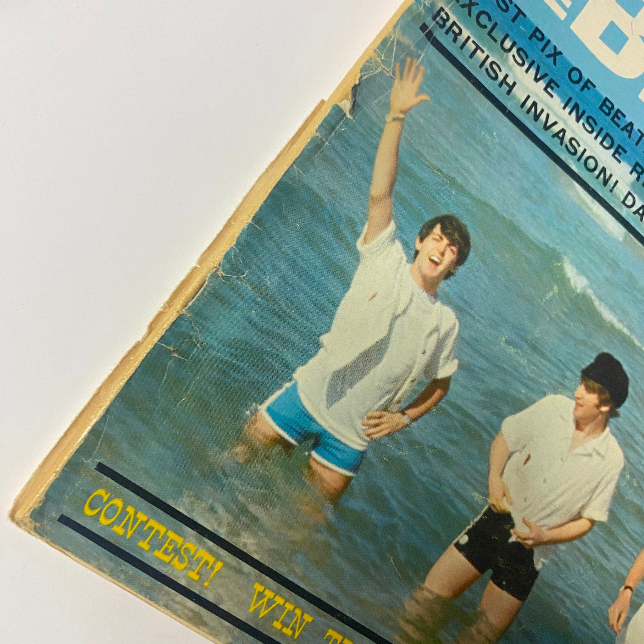 Datebook Magazine Summer 1964 featuring The Beatles on the cover, showing a young man in beachwear at the ocean. A visual representation of Beatlemania during the mid-1960s.