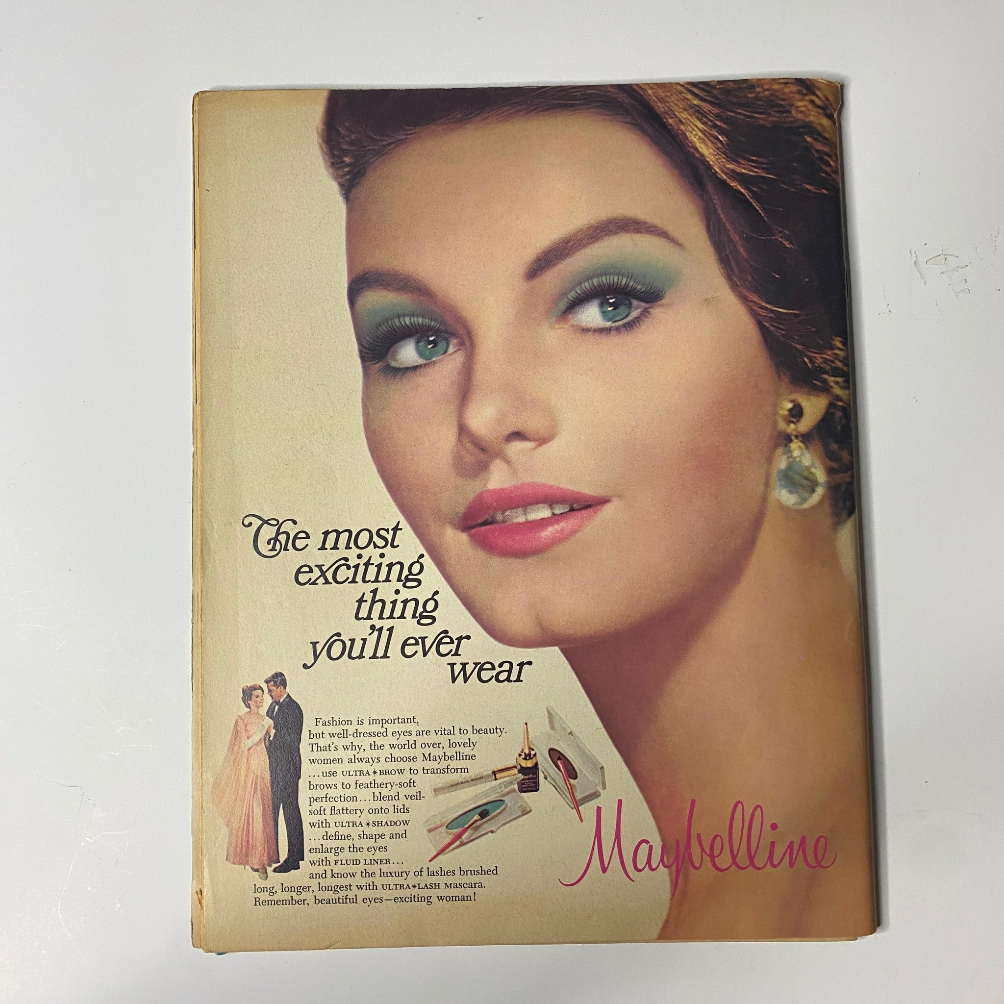 Vintage advertisement featuring a glamorous woman with styled hair and makeup, promoting Maybelline cosmetics, alongside the text 'The most exciting thing you'll ever wear'. This image relates to the theme of beauty and fashion present in the Teen Screen Magazine May 1967 featuring The Monkees cover.
