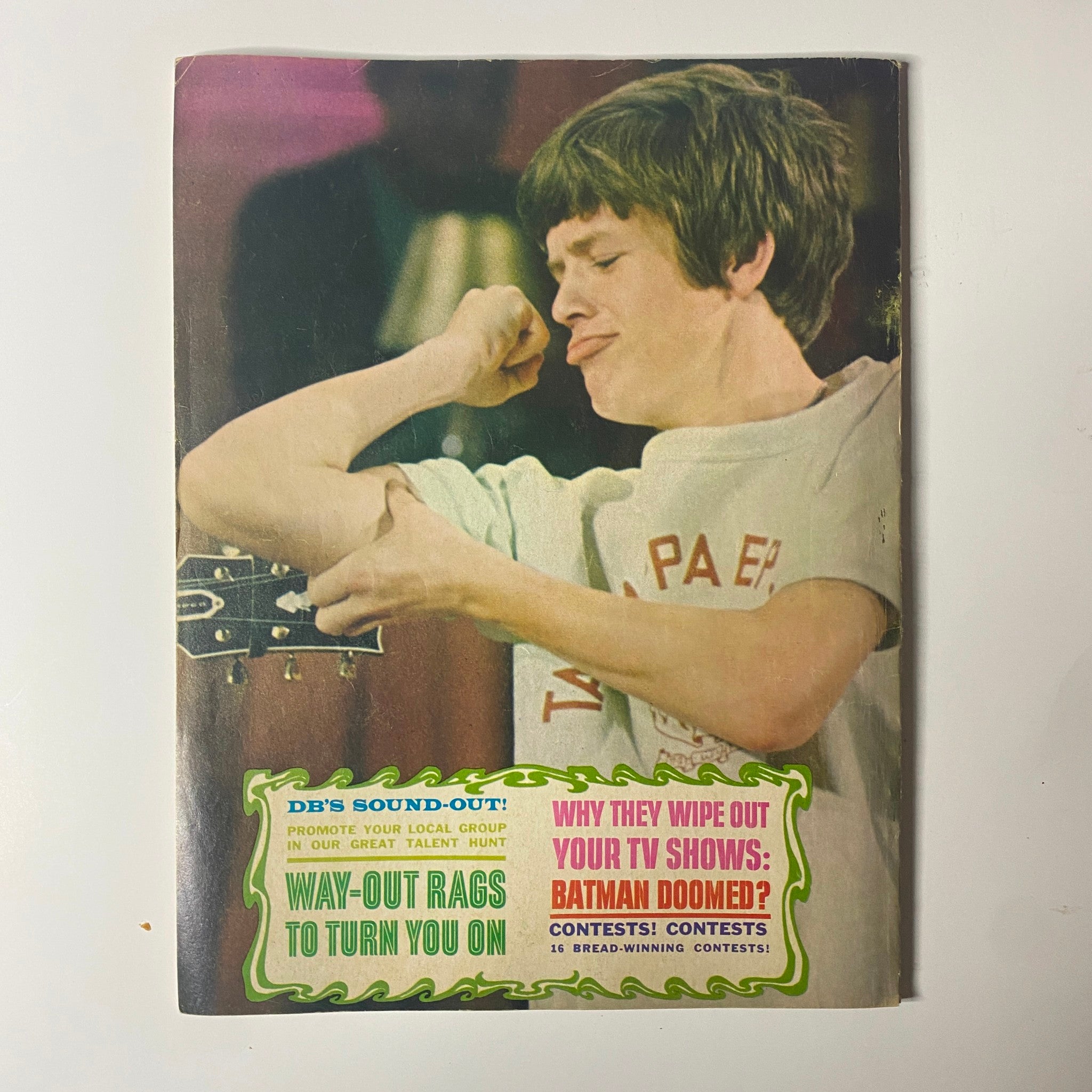 Back cover of Datebook Magazine, August 1966, Vol. 5 No. 7 showcasing a teenage boy playing guitar and highlights on contests and TV shows. The cover delivers a glimpse into pop culture during the 1960s.