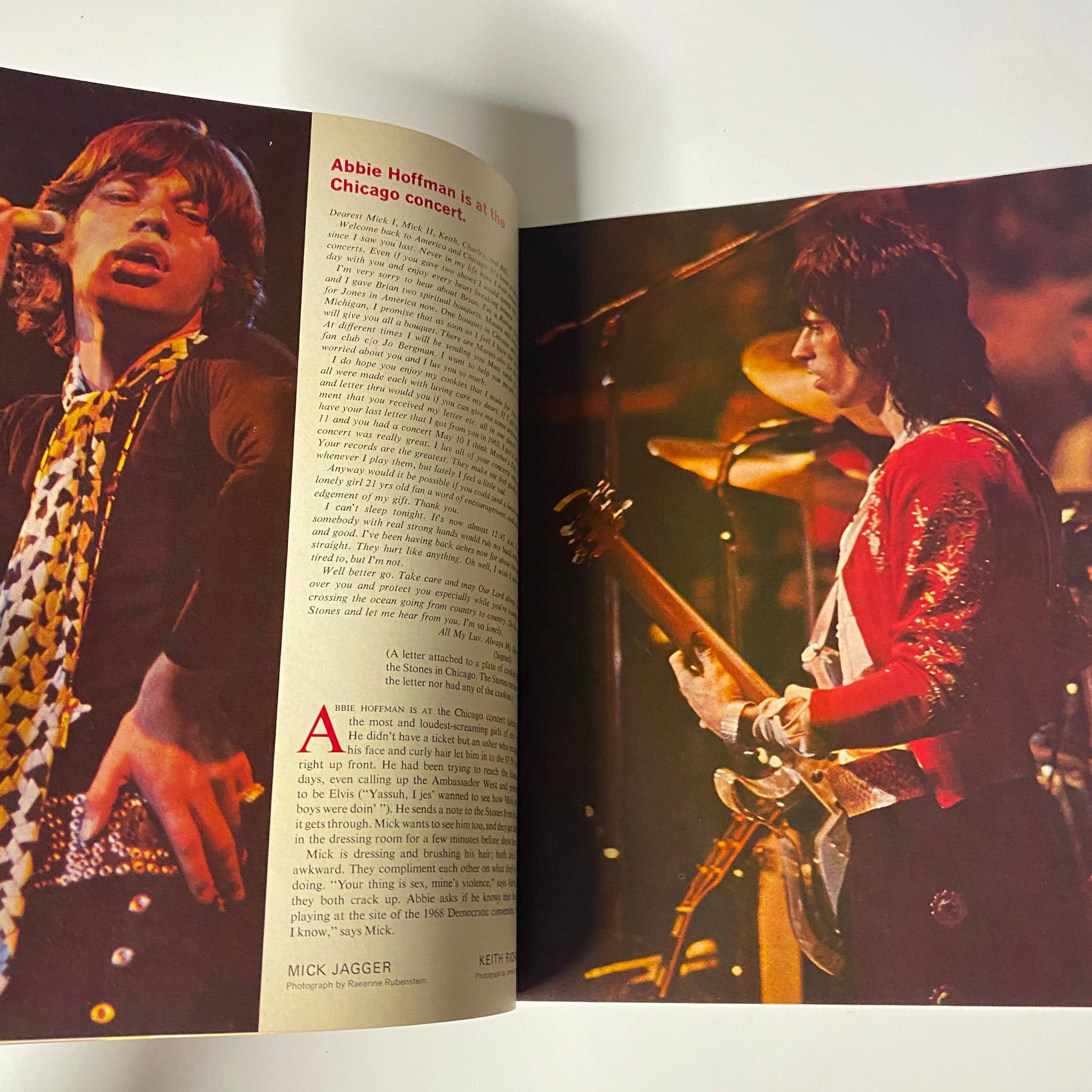 Interior page from the 1970 The Rolling Stones Discover America magazine showcasing Mick Jagger on stage during a performance and a narrative about Abbie Hoffman at a Chicago concert.