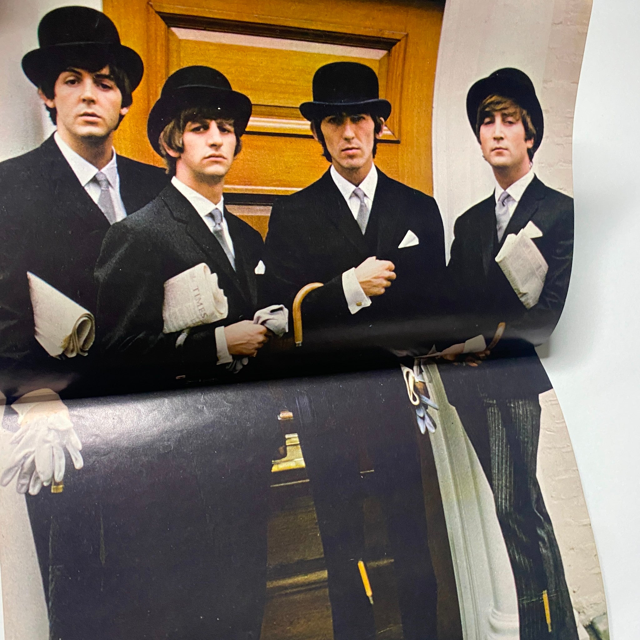 The Beatles, dressed in stylish suits and bowler hats, pose together in a vintage photograph from the 1965 16 Scoop: Beatles Complete Story from Birth to Now w Poster No Label magazine, showcasing their iconic looks during Beatlemania.