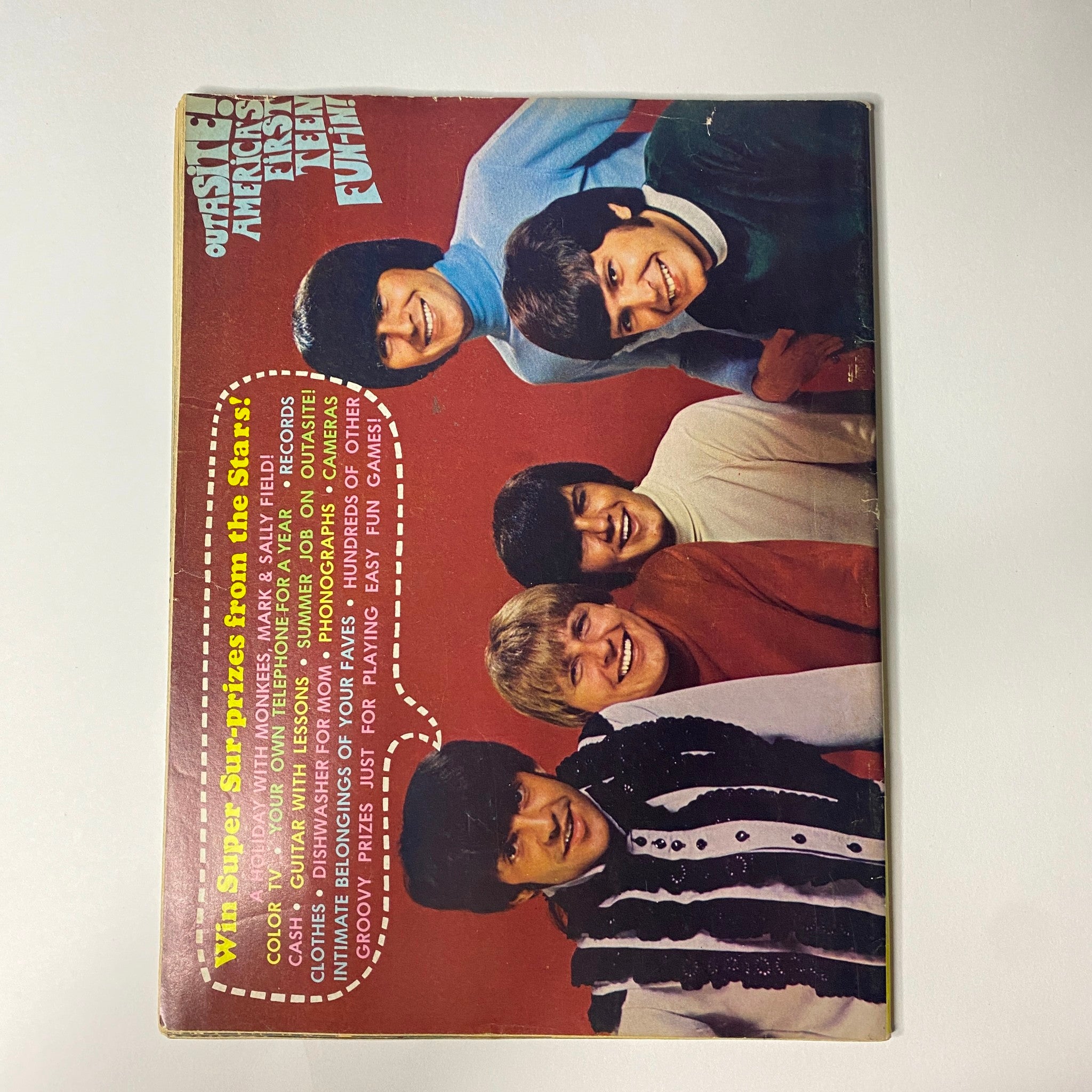 Back page of Outasite Magazine February 1967, displaying The Monkees with a colorful backdrop, emphasizing their popularity in 1960s teen culture.