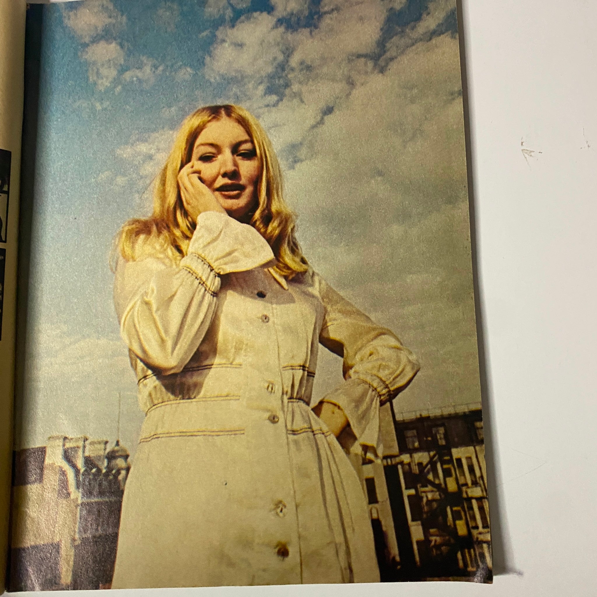 A candid image from TeenSet Magazine January 1969 Vol. 5 No. 1 featuring a stylish woman against a cloudy sky, embodying the fashion of the era.