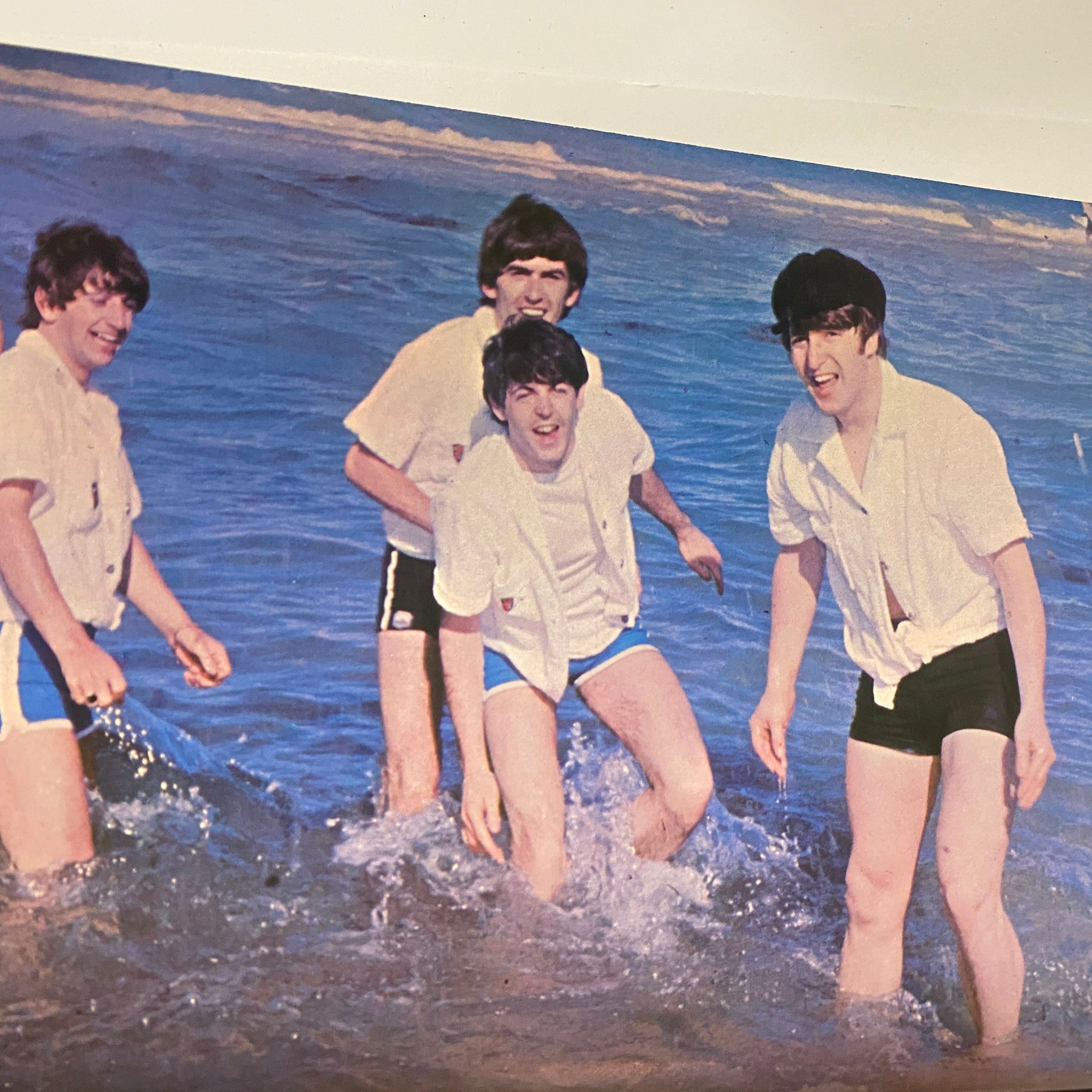 Image from 'Welcome Back The Beatles Part II' depicting the Beatles playing in the ocean, captured in a playful moment.