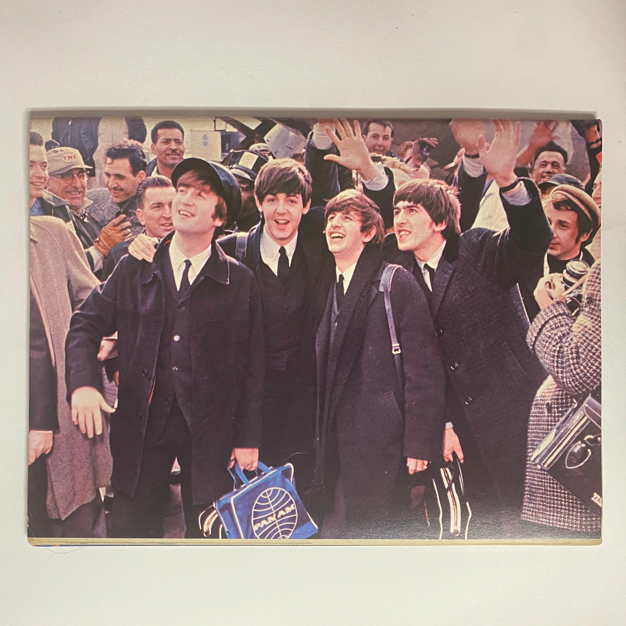 1977 Welcome Back The Beatles Part II No Label VG - A classic photograph from the 1960s showing The Beatles, smiling and waving to fans, capturing the band's charismatic presence and influence on music culture.