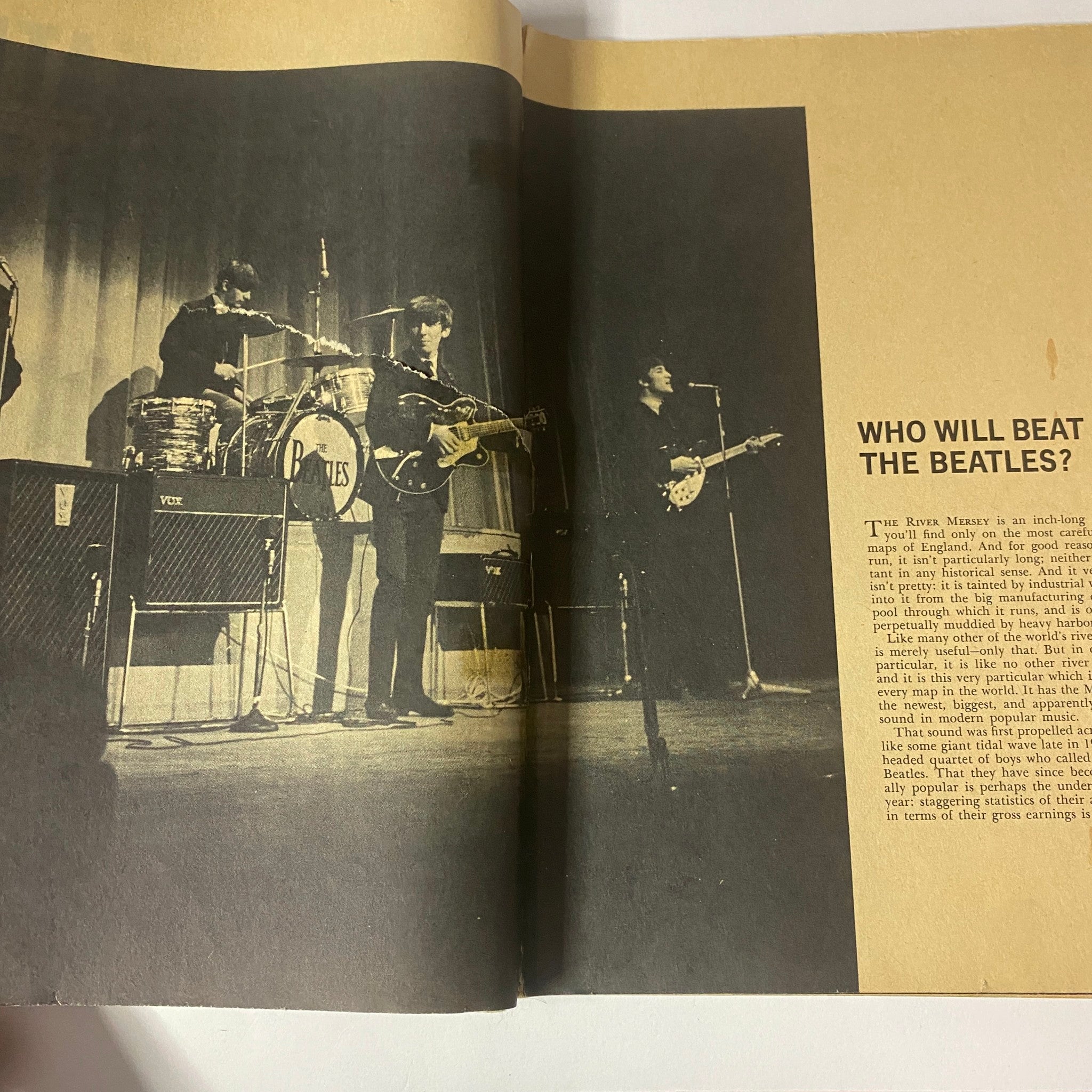 Historic photo of The Beatles performing live in a magazine spread from 'Who Will Beat The Beatles? The Mersey Sound Hits America'.