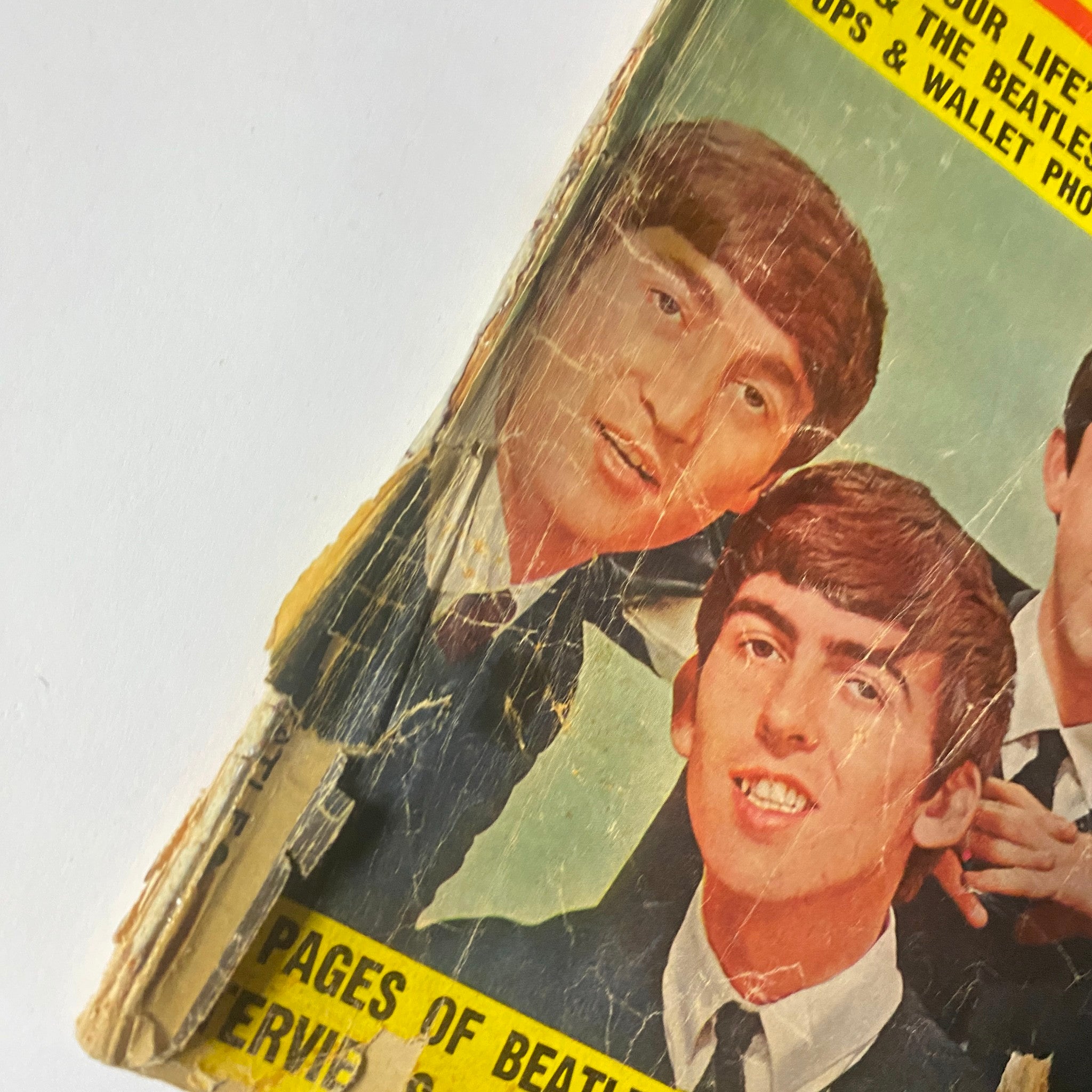 Cover of 1964 All About The Beatles No. 1 magazine, featuring a vintage image of George Harrison and Paul McCartney, showing wear with visible creases.