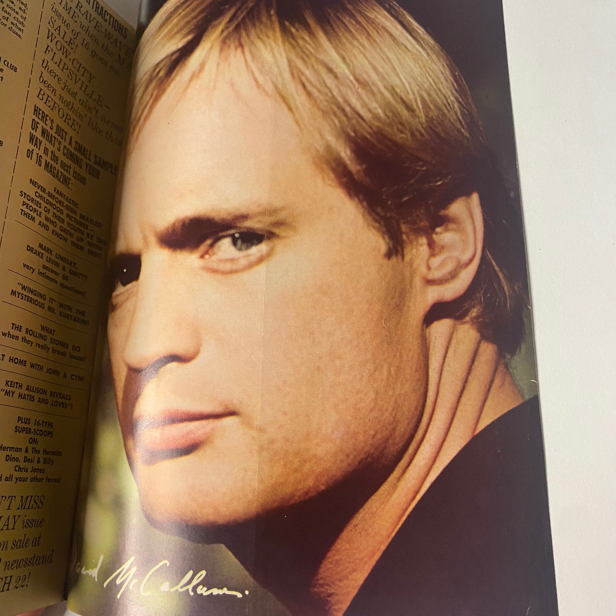 David McCallum featured in 16 Magazine April 1966, captured in a striking close-up with a serious expression and signature, exemplifying cool sophistication of the era.