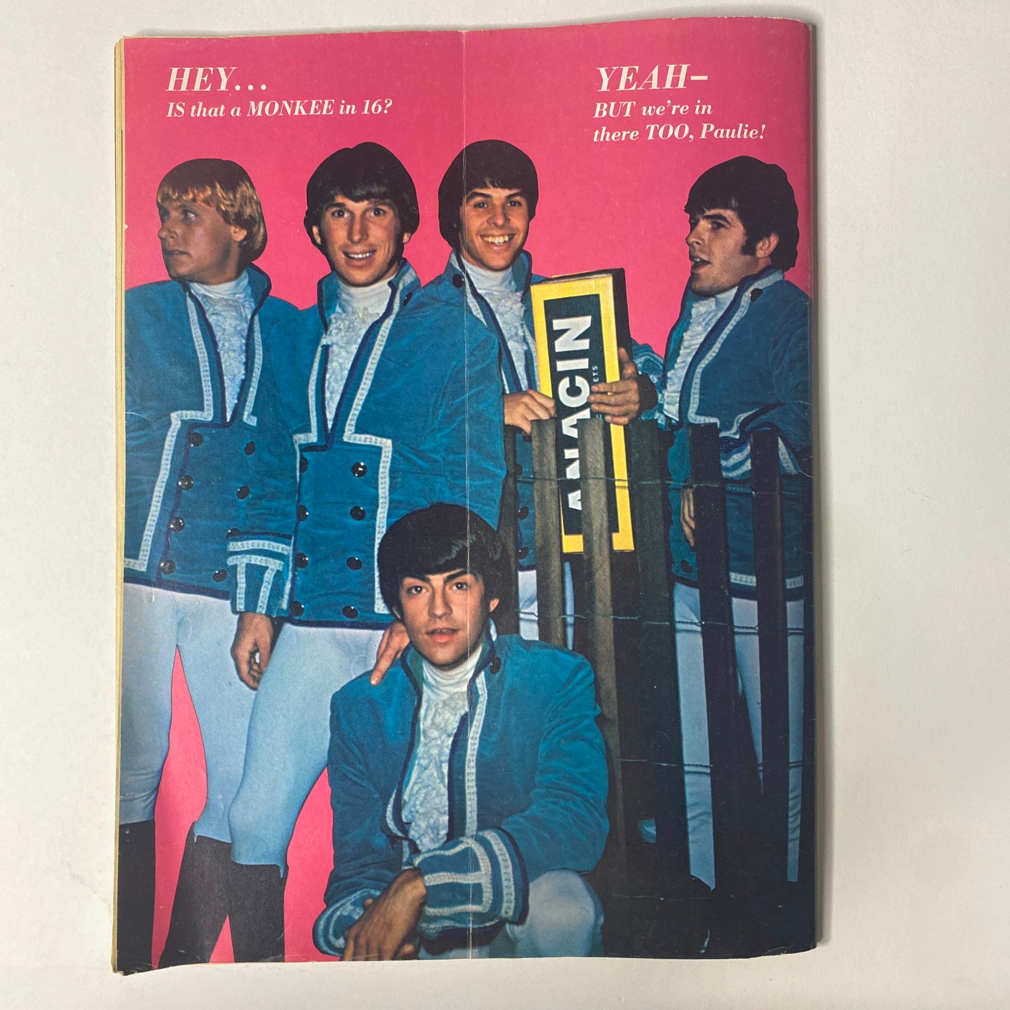 A group shot of The Monkees dressed in colorful outfits from 16 Magazine April 1967 Vol 8 No. 11, highlighting their pop culture status.