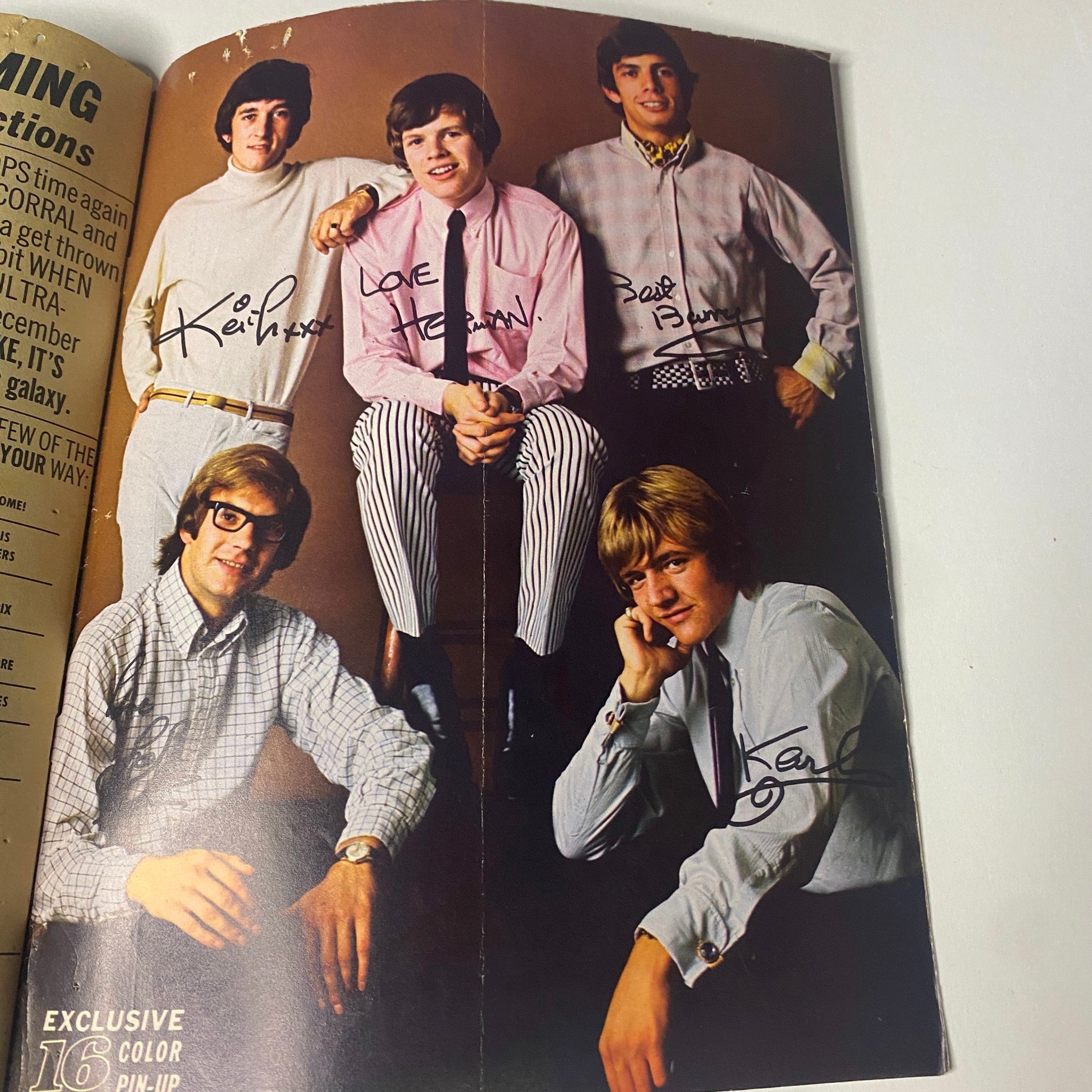 Group photo of Paul Revere & The Raiders showcasing signed color pin-ups from '16 Magazine November 1966 Vol 8 No. 6'.