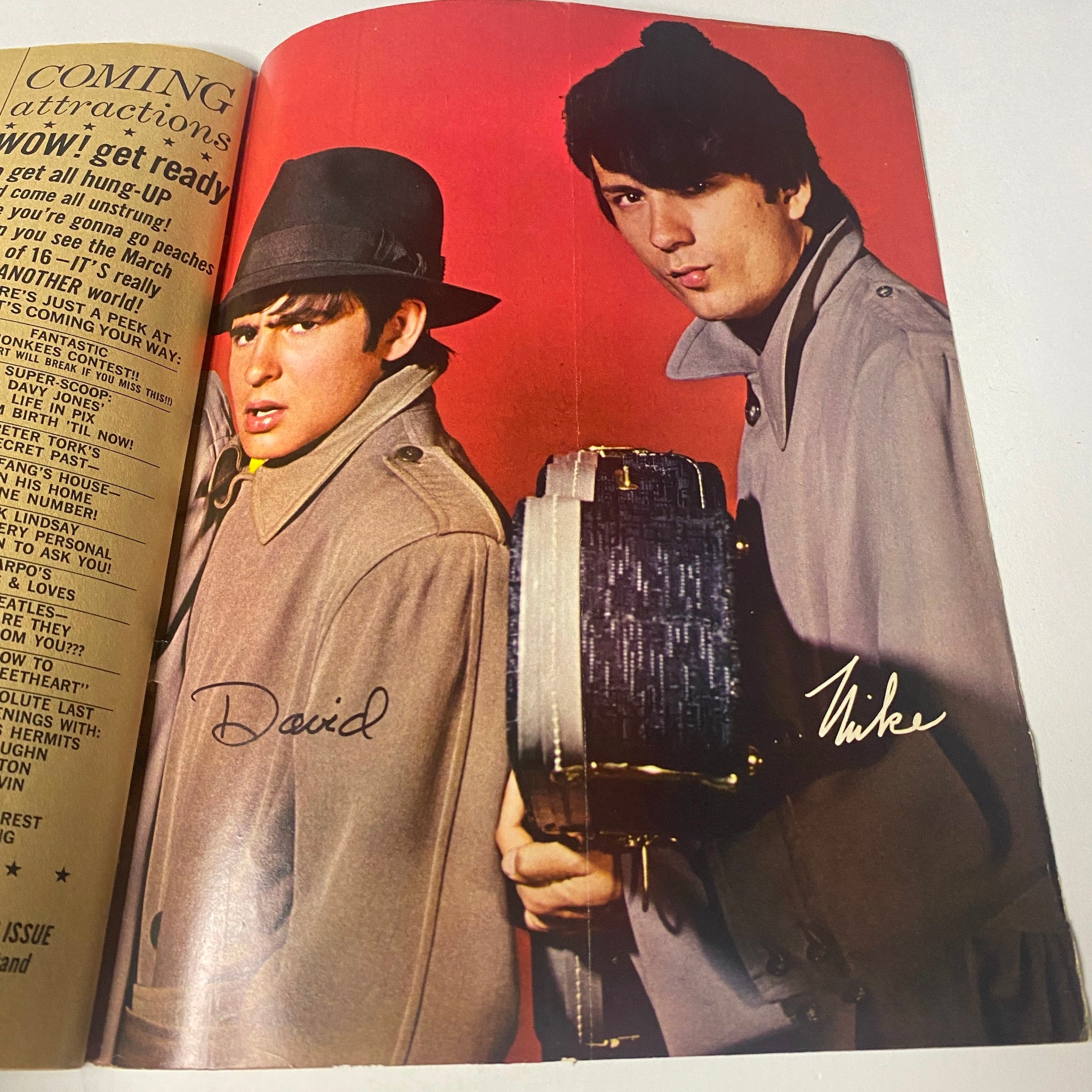 David Jones and Mike Nesmith in stylish trench coats from 16 Magazine February 1967 Vol 8 No. 9, representing The Monkees in a movie-like scene.
