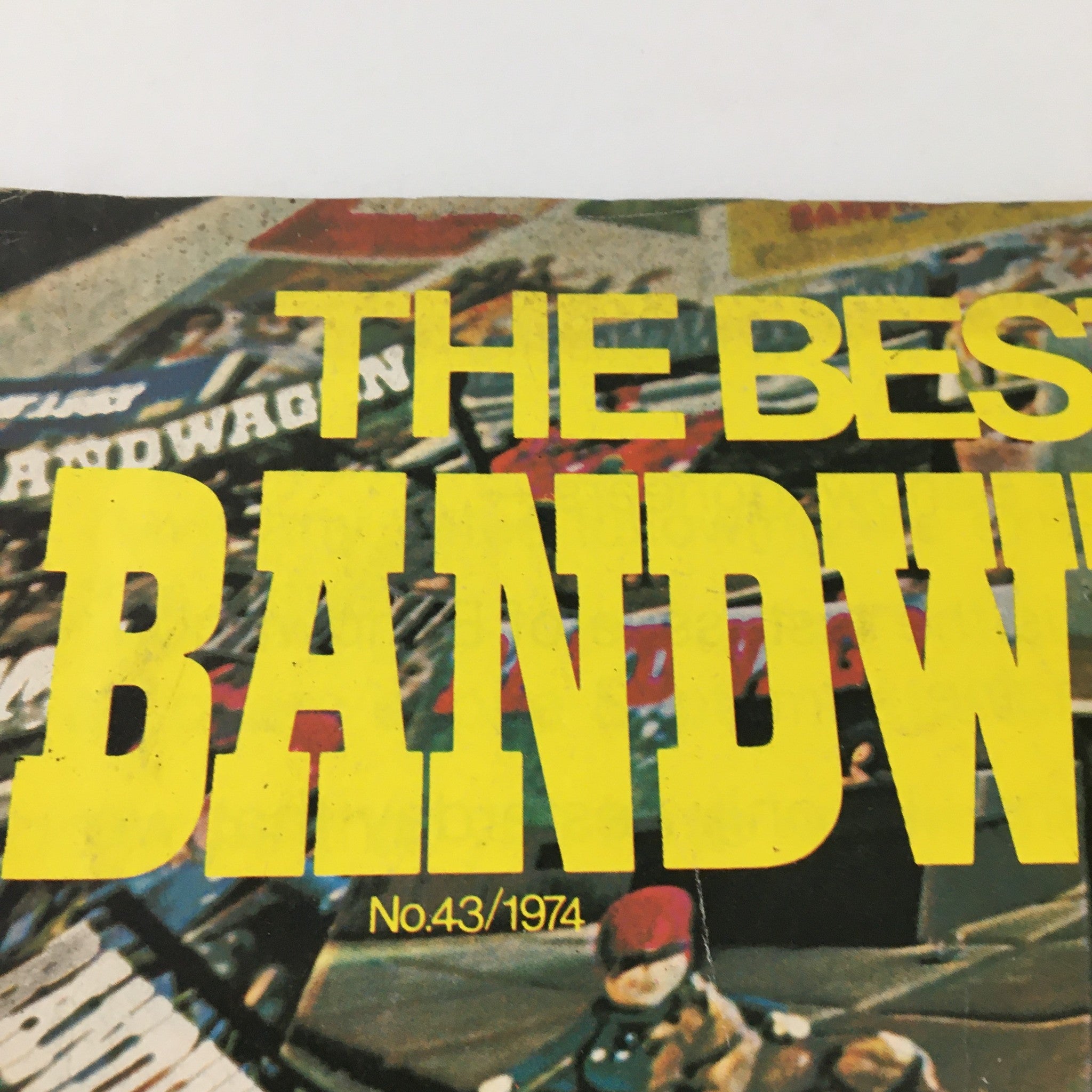 Cover of VTG The Best of Bandwagon Magazine 1974 Number 43, showcasing vibrant yellow typography with the title 'THE BEST BANDWAGON No.43/1974' against a background of music-related imagery.