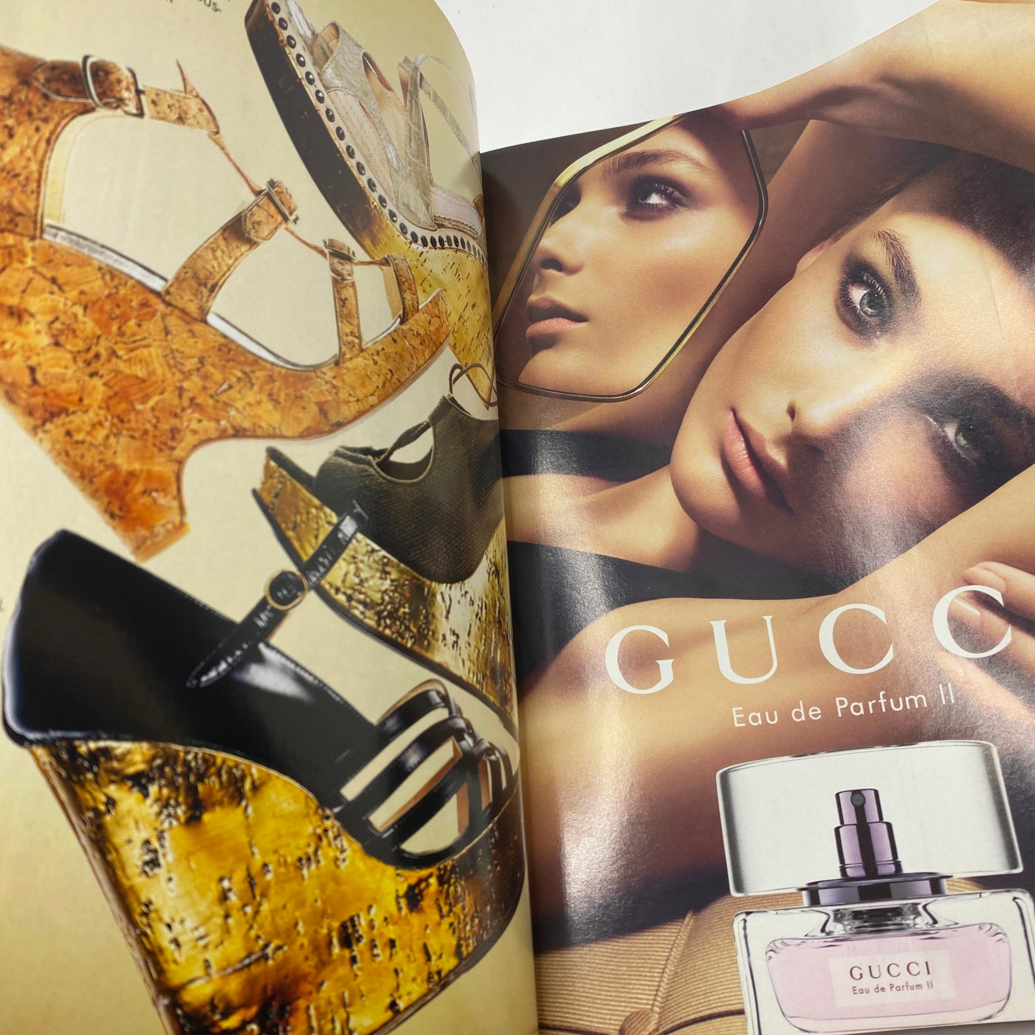 Inside spread of Elle Magazine December 2006 showcasing high fashion advertisements, including Gucci's Eau de Parfum.