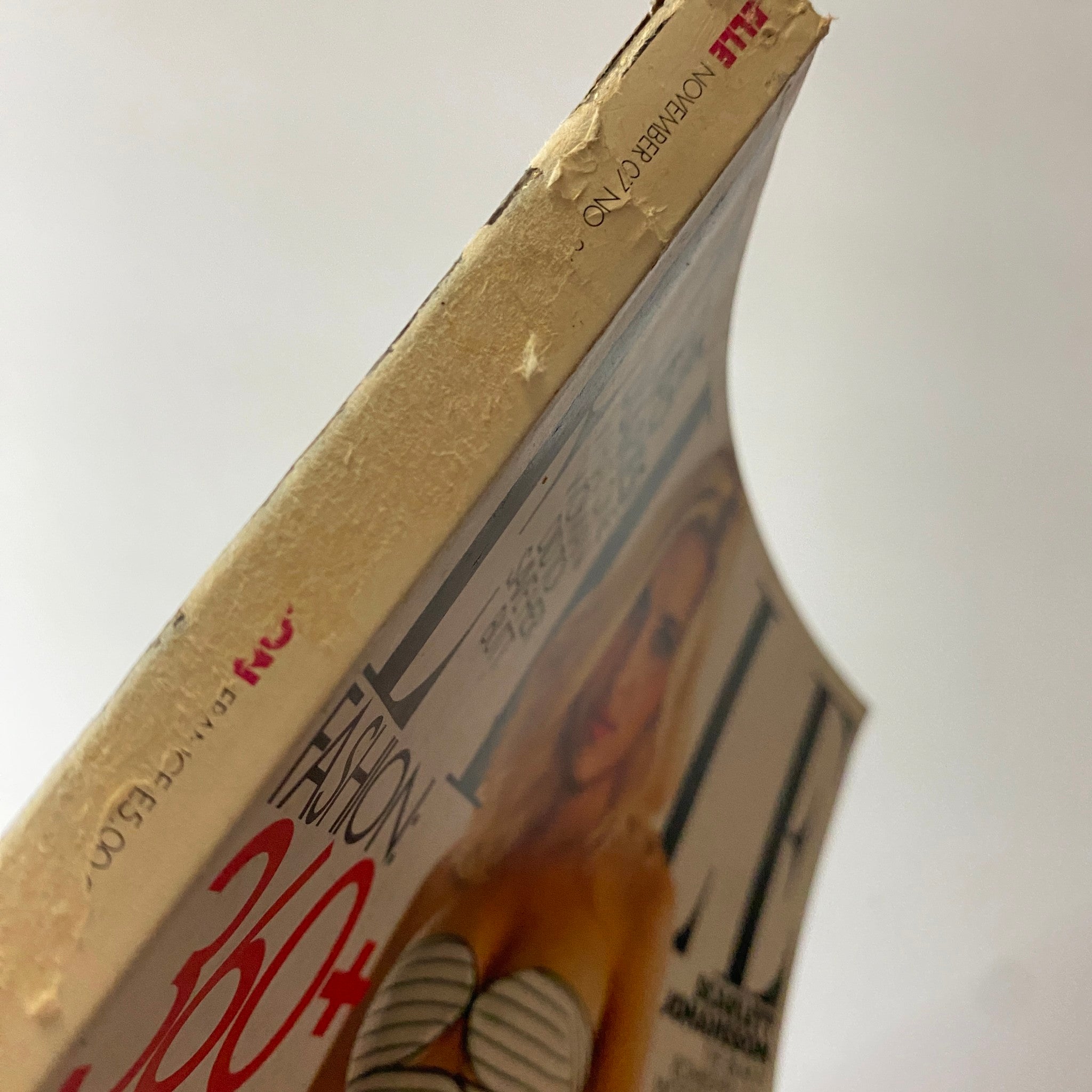 Close-up view of the side spine of Elle Magazine November 2007, featuring Scarlett Johansson, revealing the magazine's vintage condition and wear typical for its age.