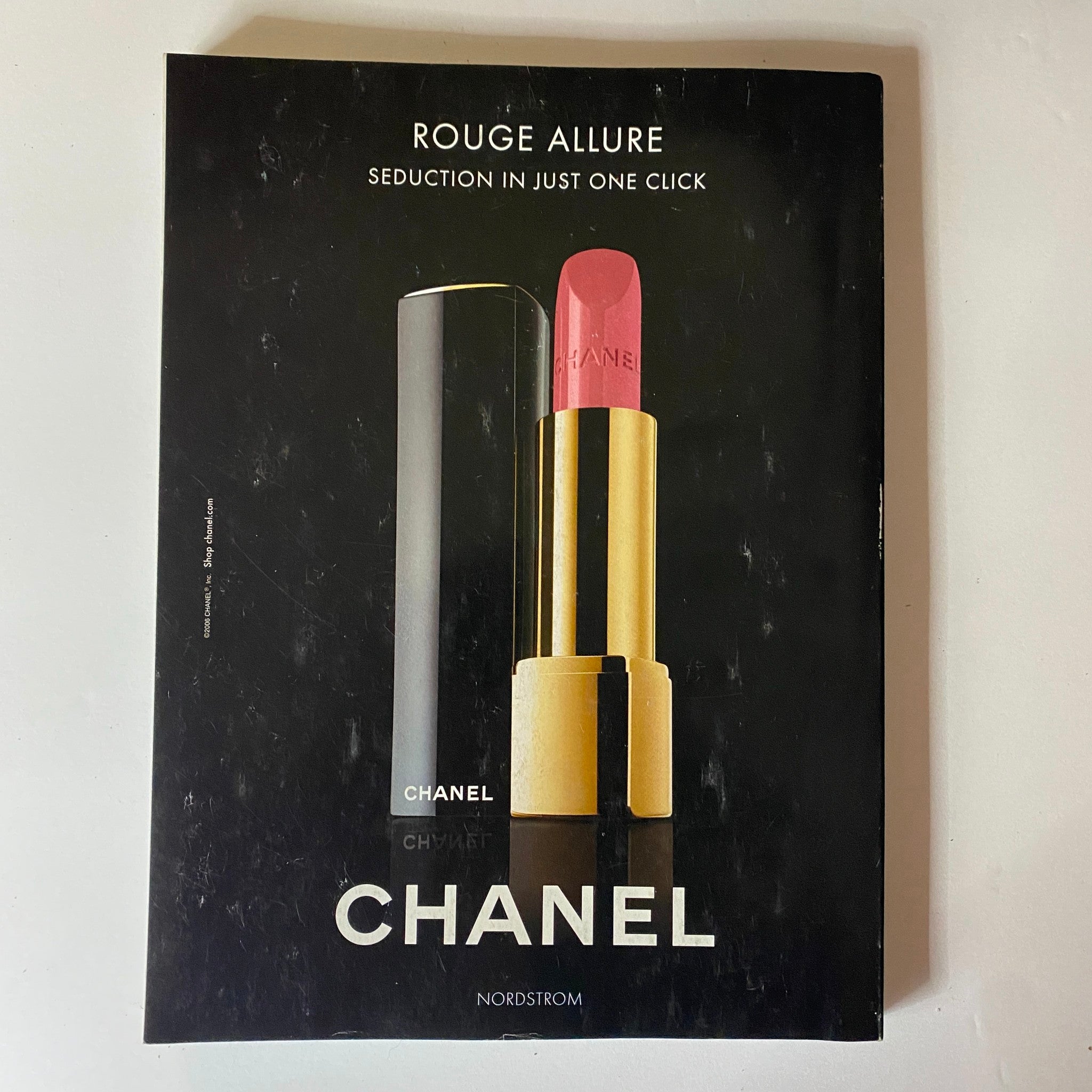 Advertisement page from Elle Magazine November 2006 promoting Chanel's Rouge Allure lipstick, highlighting elegance and luxury in beauty products.