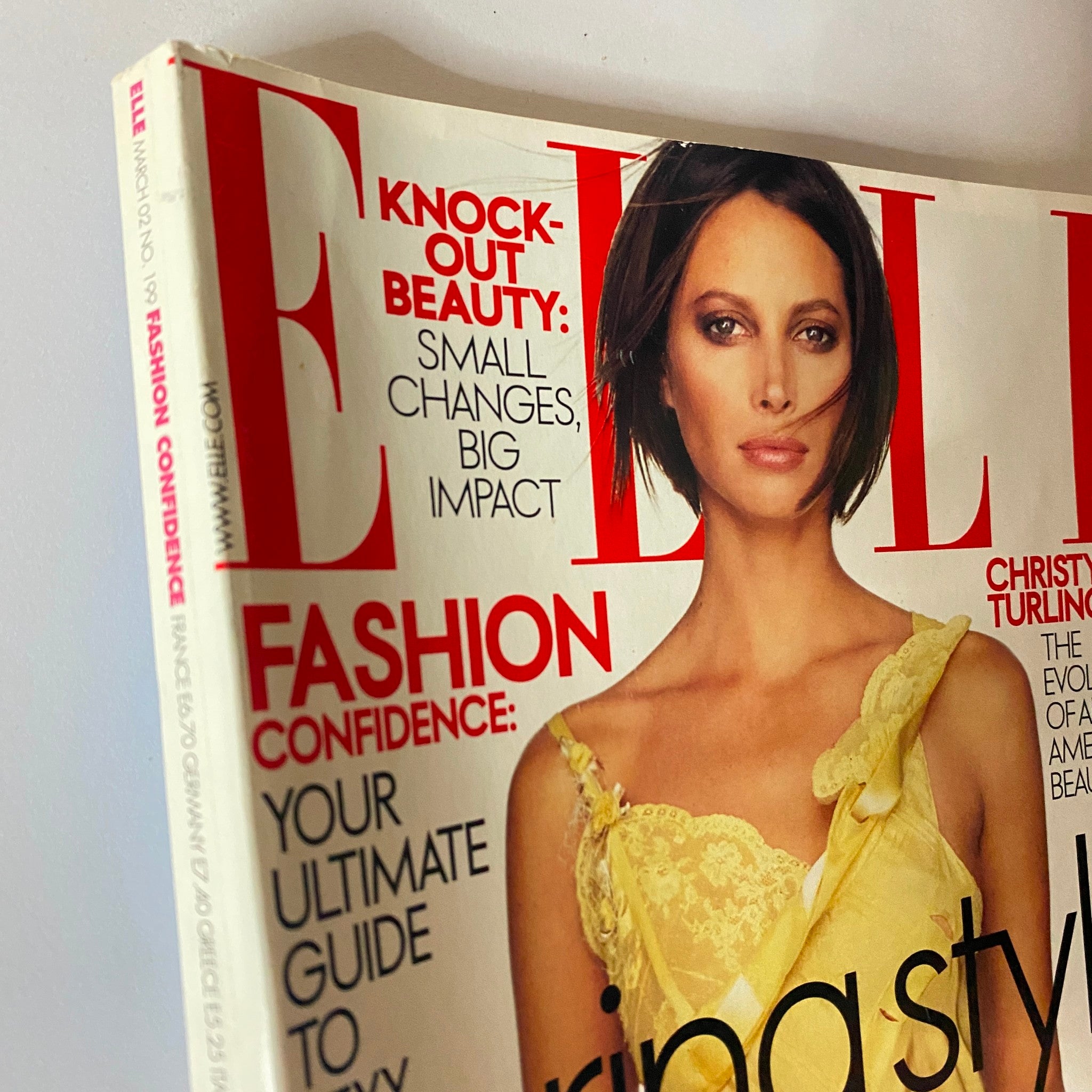 Elle Magazine March 2002 cover featuring supermodel Christy Turlington with the tagline 'Knock-out Beauty: Small Changes, Big Impact' showcasing fashion confidence and highlighting stunning visuals.