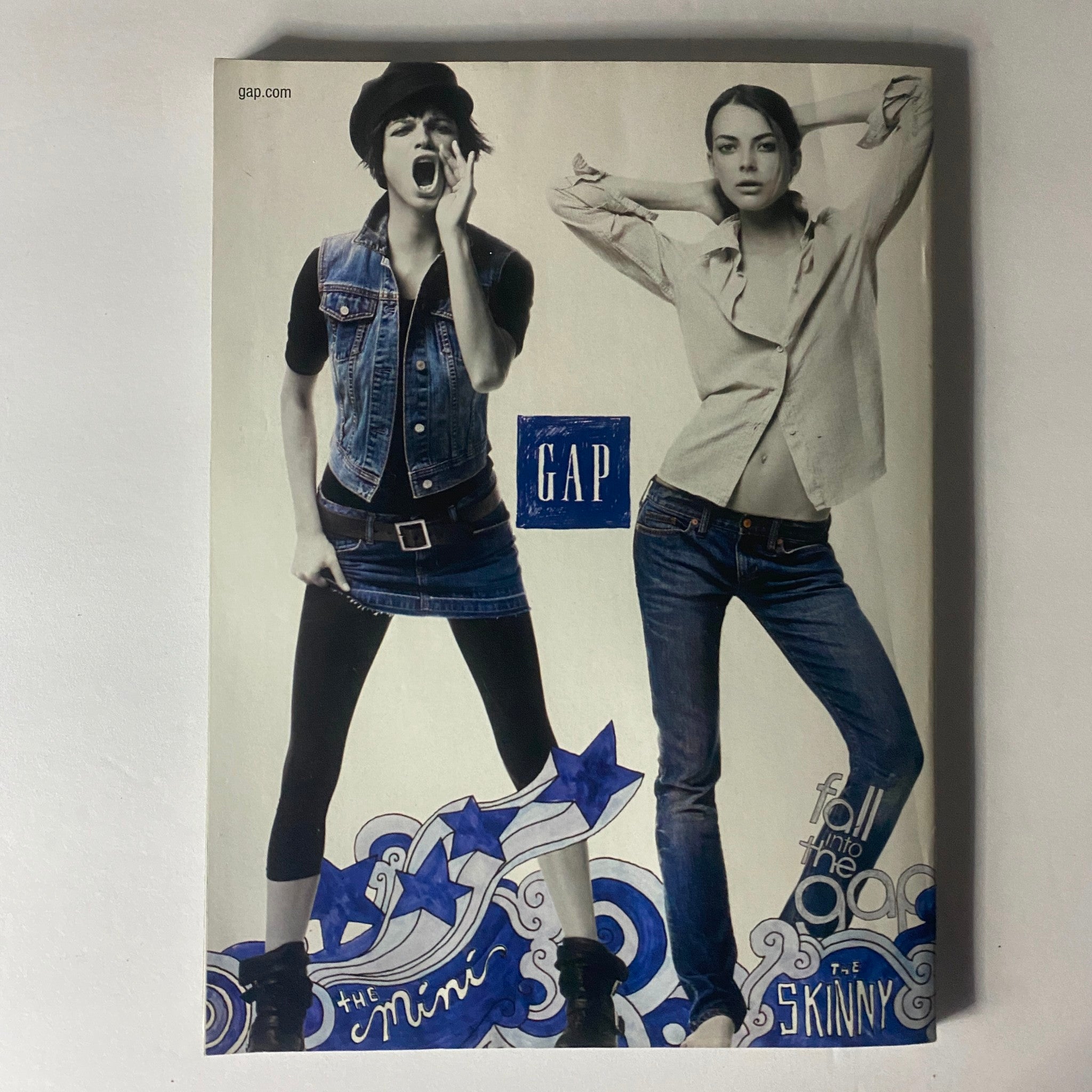 Elle Magazine August 2006 features a fashion advertisement for GAP showcasing a stylish denim ensemble and poses promoting trendy fall looks.