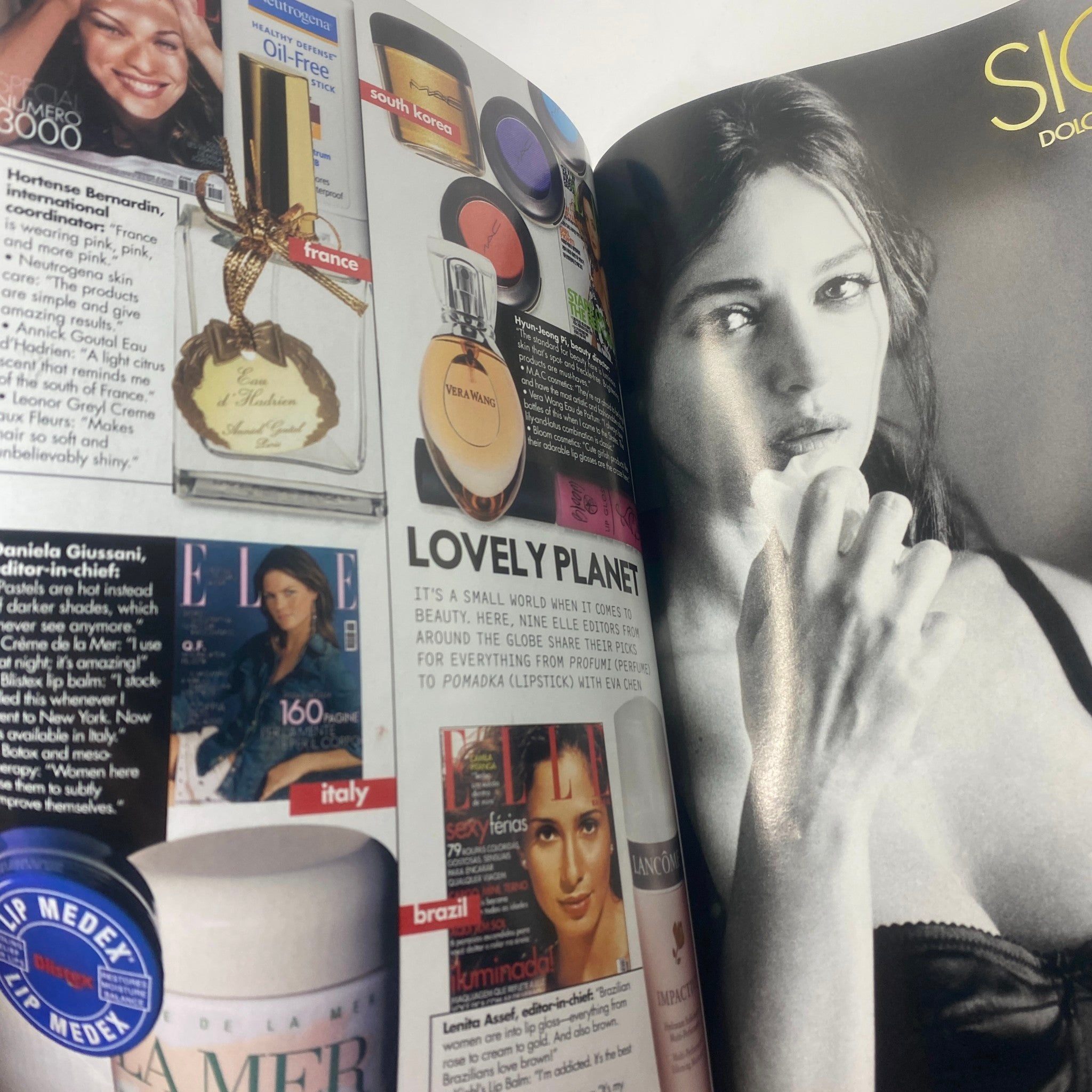 Inside pages of Elle Magazine October 2003 featuring cosmetics and beauty products with a model in black and white, representing the beauty trends of the early 2000s.