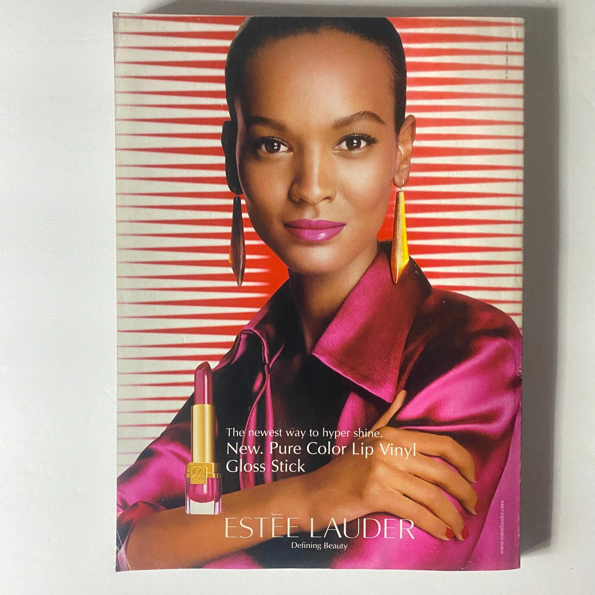 Back cover of Elle Magazine October 2003 showcasing an Estee Lauder advertisement with a model, emphasizing beauty and fashion from the period.