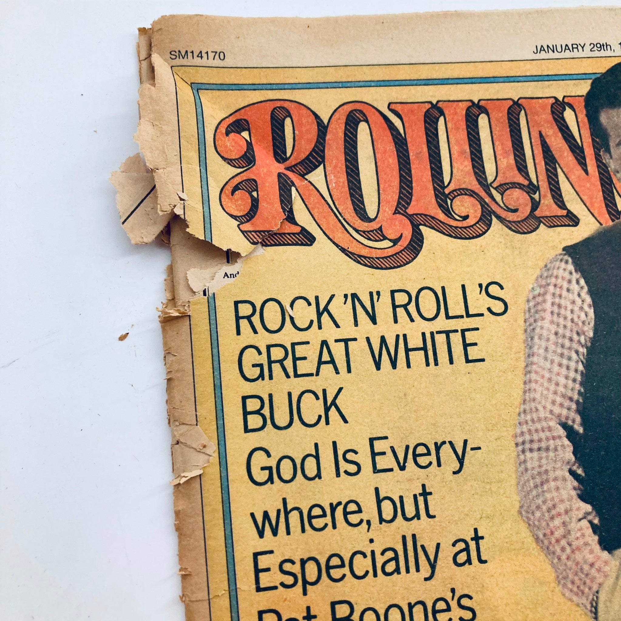 Close-up of the Rolling Stone Magazine cover, January 29, 1976 Issue 205, highlighting the text 'Rock 'n Roll's Great White Buck' and featuring Pat Boone, with notable wear on the edges.