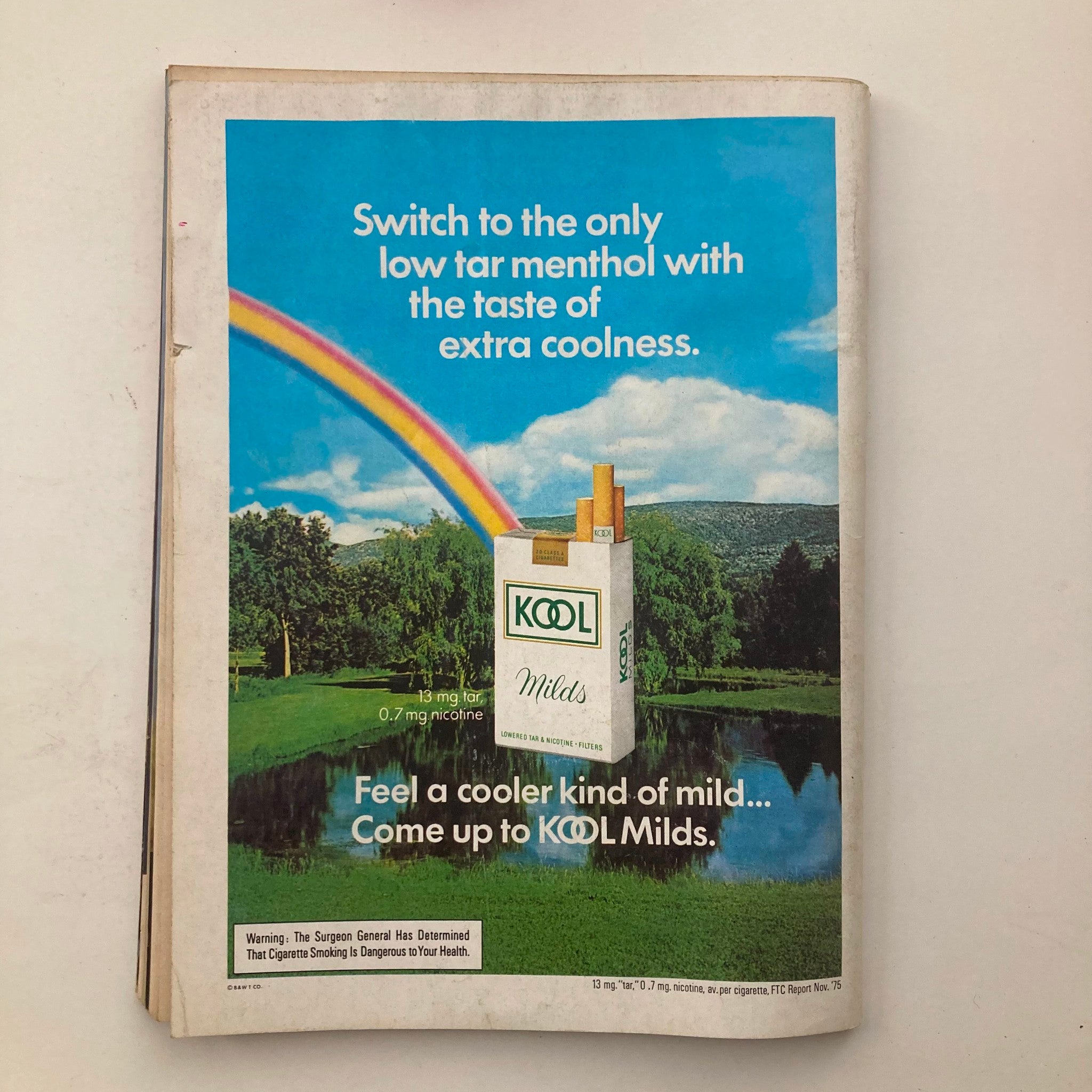 Vintage advertisement from the VTG Playboy Magazine March 1976 for KOOL Milds cigarettes, featuring a scenic landscape with a rainbow.