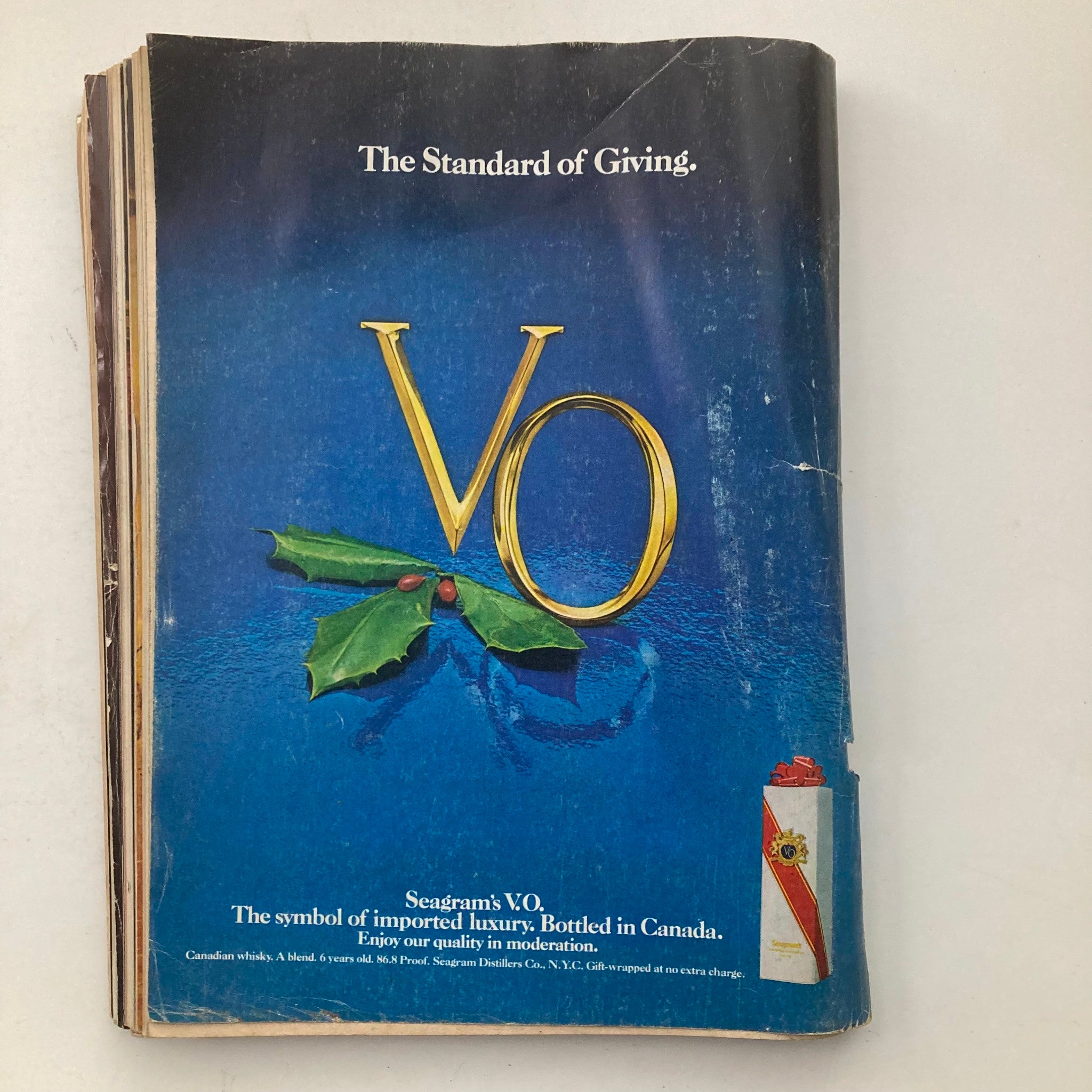 Ad from the VTG Playboy Magazine December 1979, showcasing Seagram's V.O. whisky, featuring elegant blue and gold design with holiday motifs.